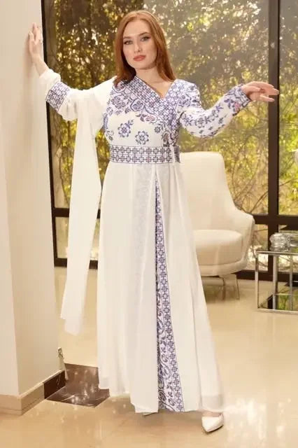 White traditional Palestinian embroidery dress with blue floral patterns by Palestinian Elegance