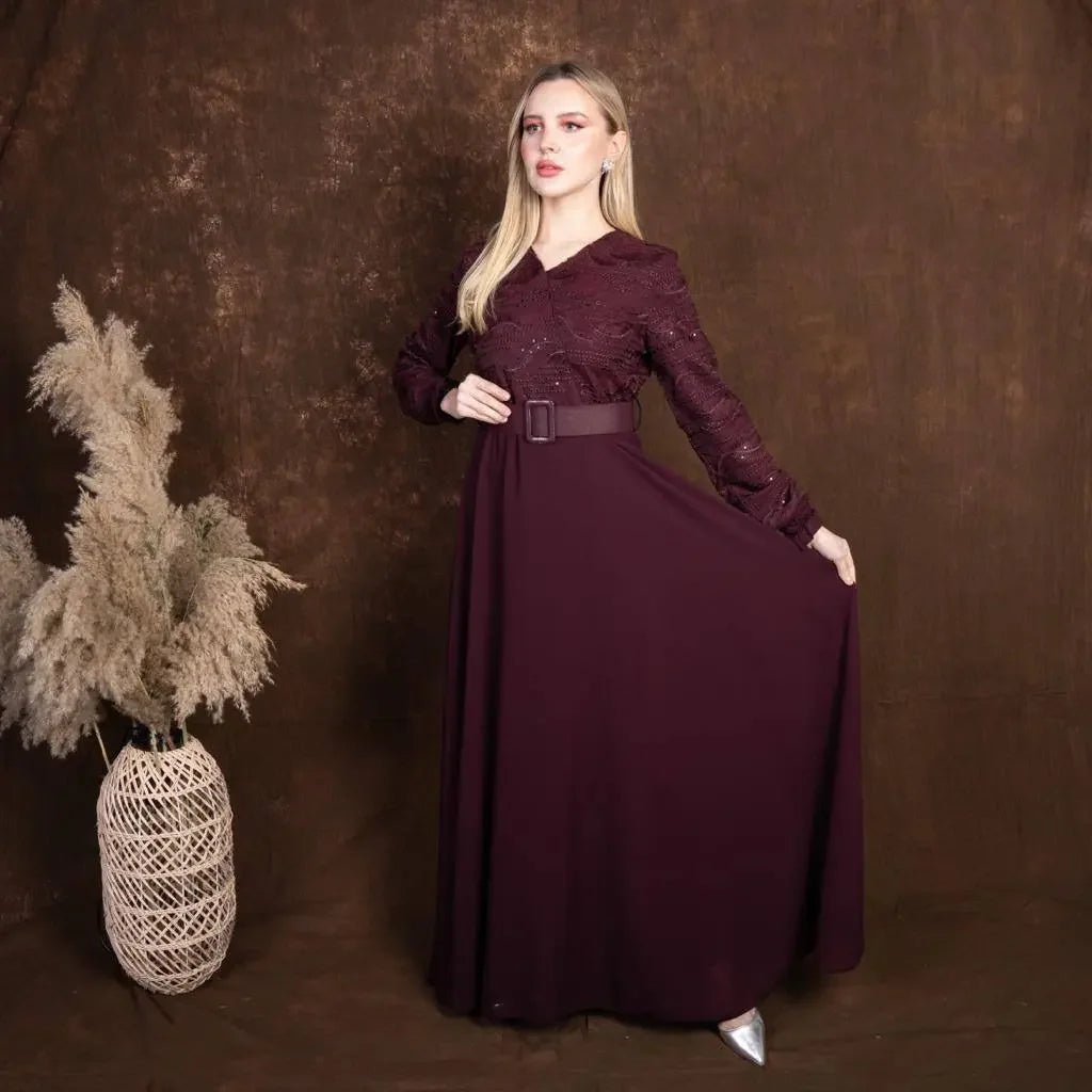Palestinian Elegance burgundy tulle dress with long sleeves and belted waist on model