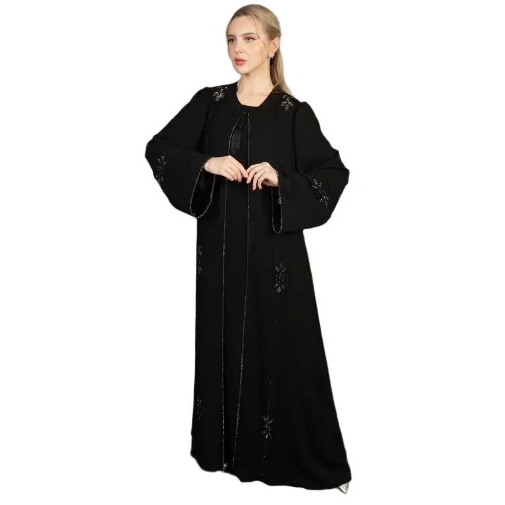 Palestinian Elegance black abaya with floral embroidery on sleeves and front worn by model