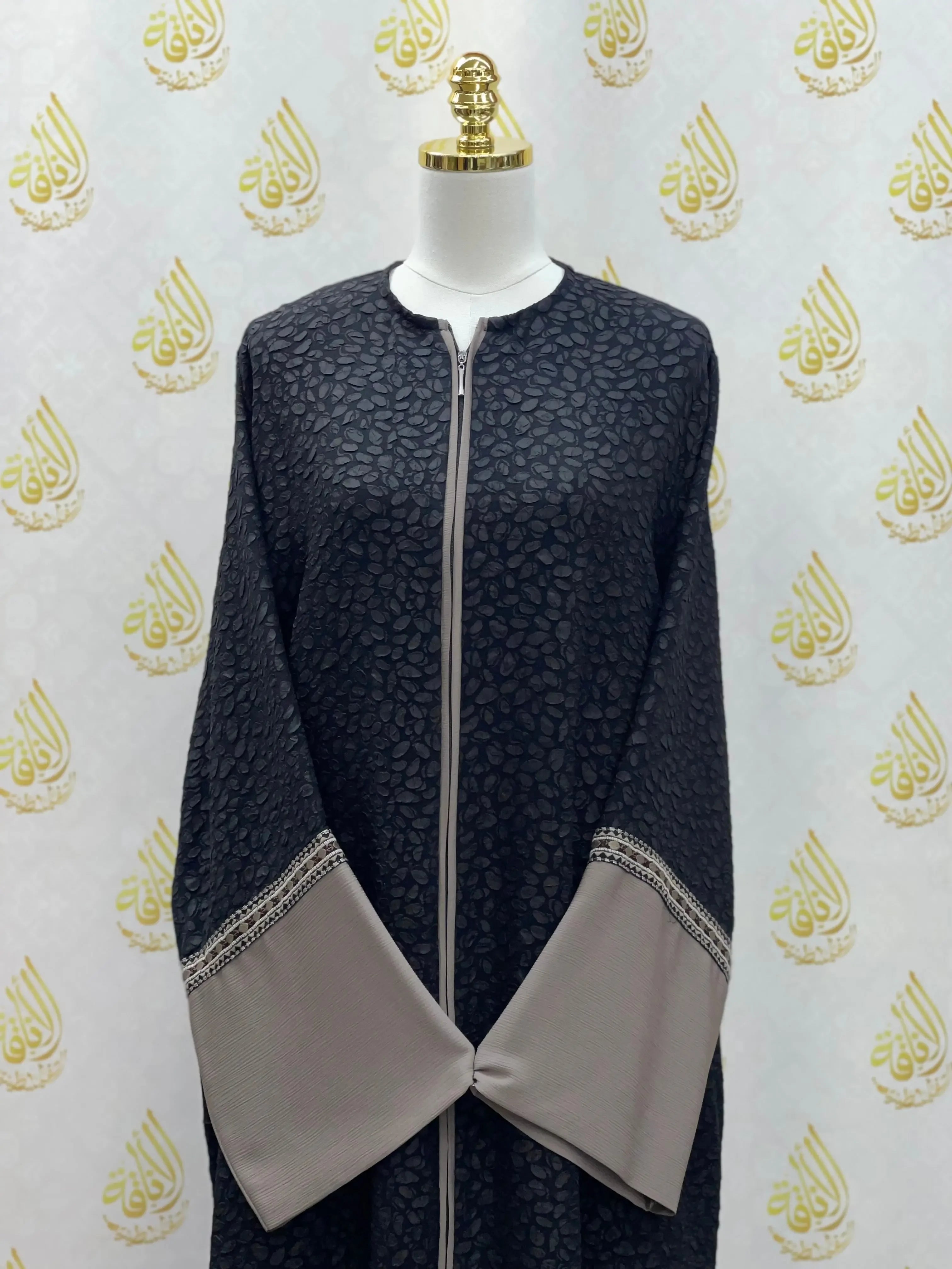 Palestinian Elegance chic abaya for women in black patterned fabric with taupe wide sleeves and front zipper