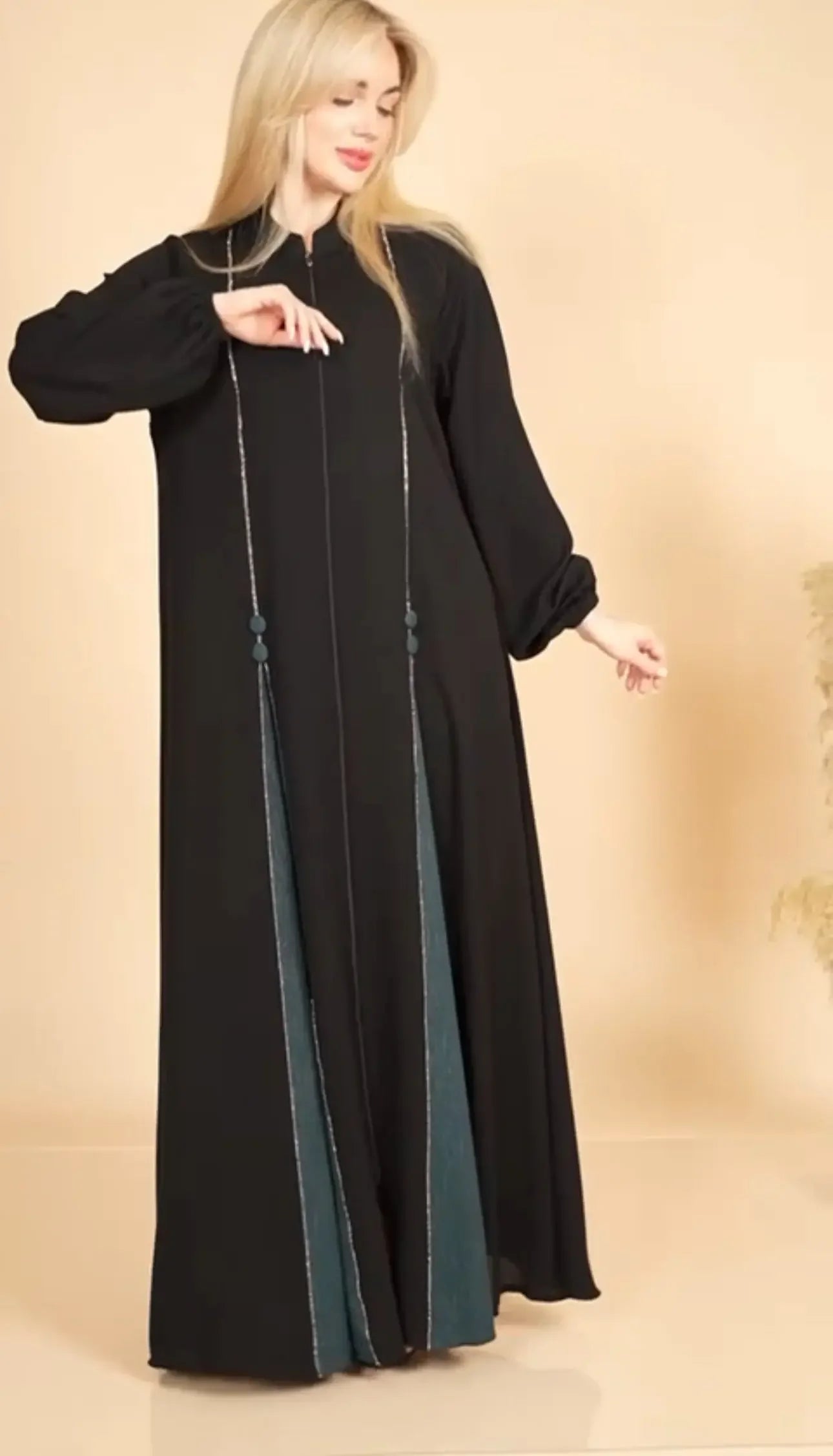 Elegant abaya for women by Palestinian Elegance featuring black fabric with teal accents and long sleeves