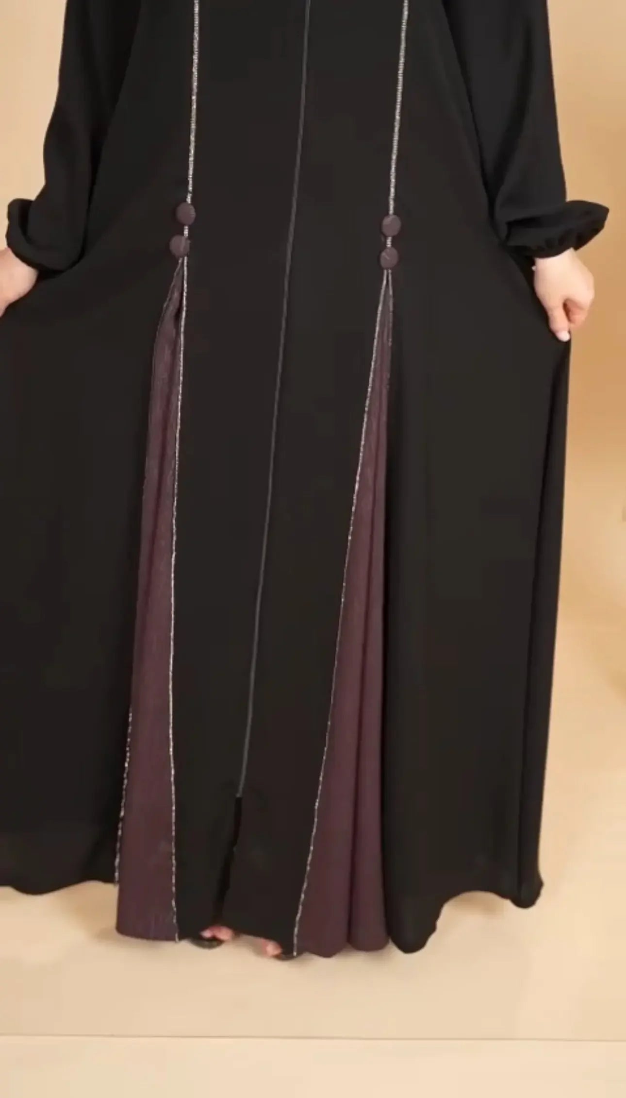 Palestinian Elegance elegant abaya for women in black with detailed front tassels and maroon inner fabric