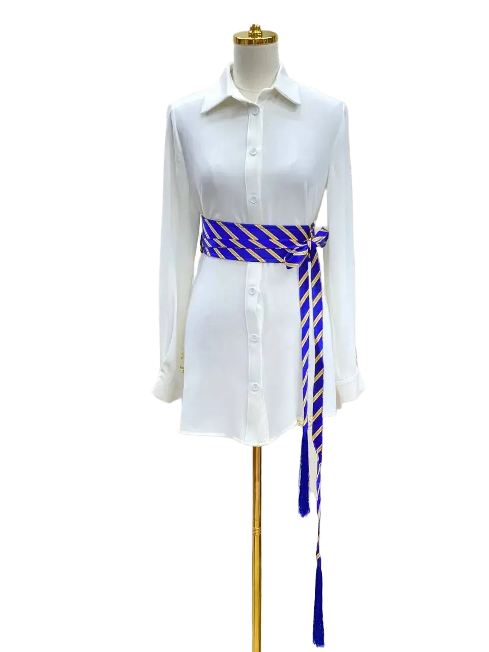 White button-down dress styled with a blue and gold embroidered kashmir belt by Palestinian Elegance