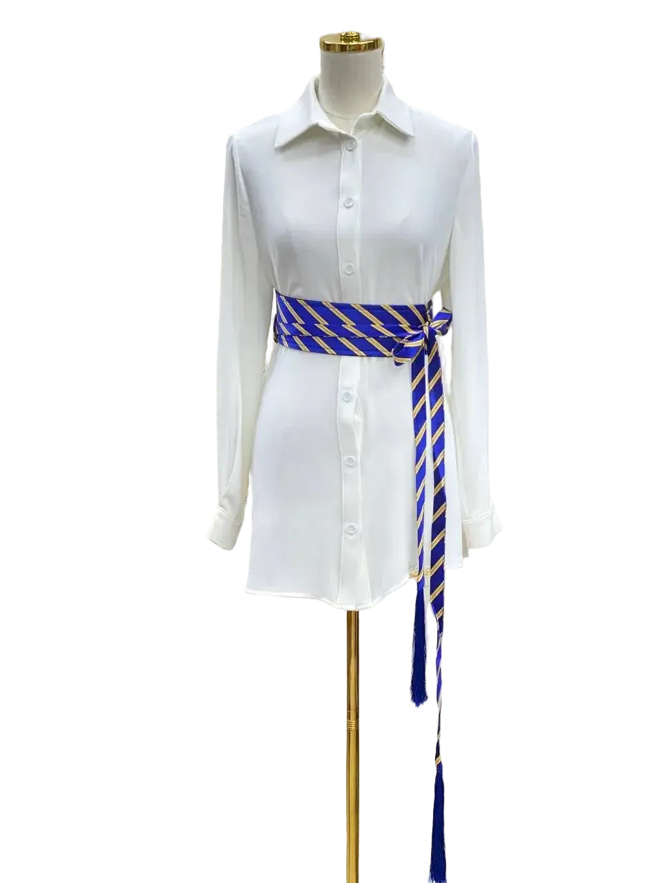 Embroidered kashmir belt in blue and gold wrapped around a white button-up dress on a mannequin