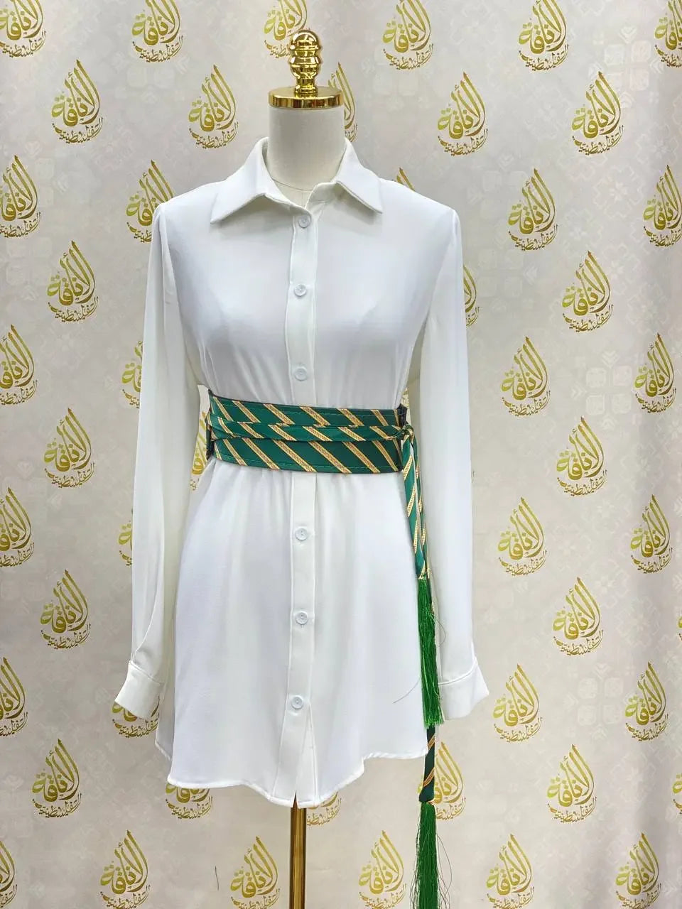 White shirt dress styled with a green and gold embroidered kashmir belt featuring tassels