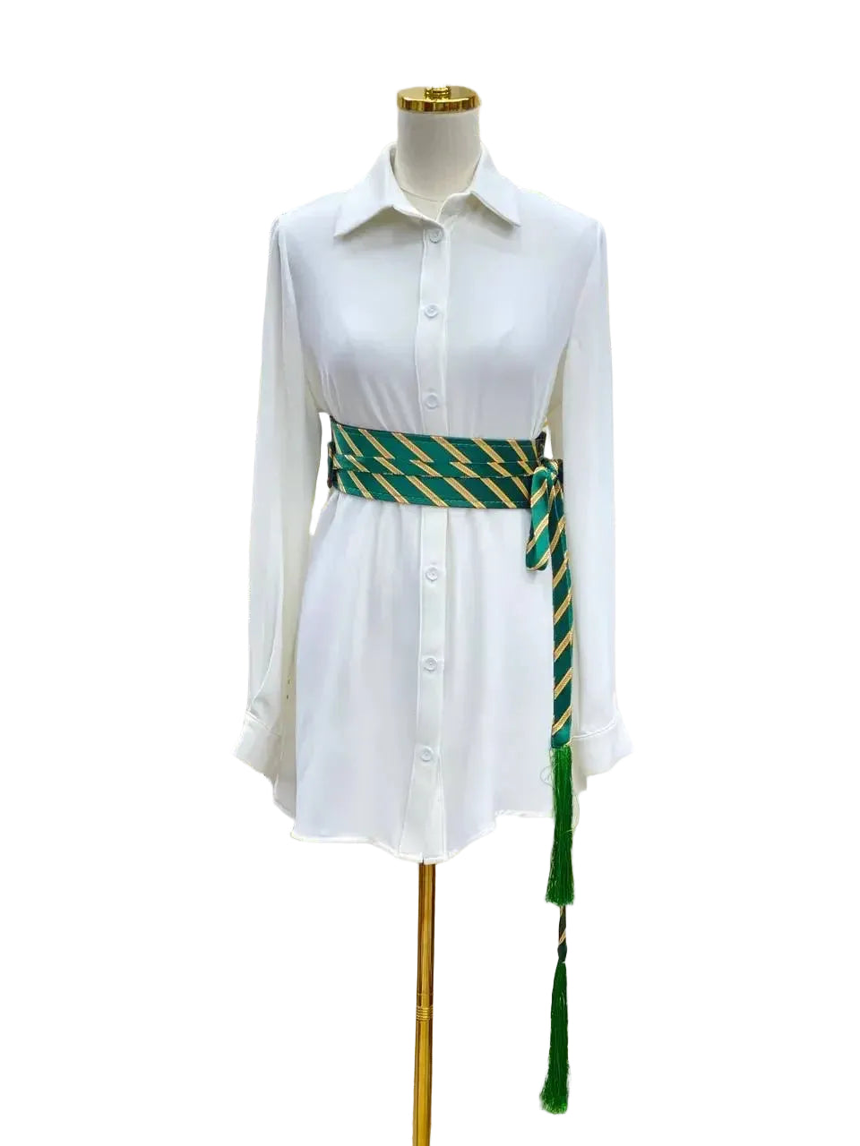 Embroidered kashmir belt in green and gold wrapped around a white shirt dress on a mannequin