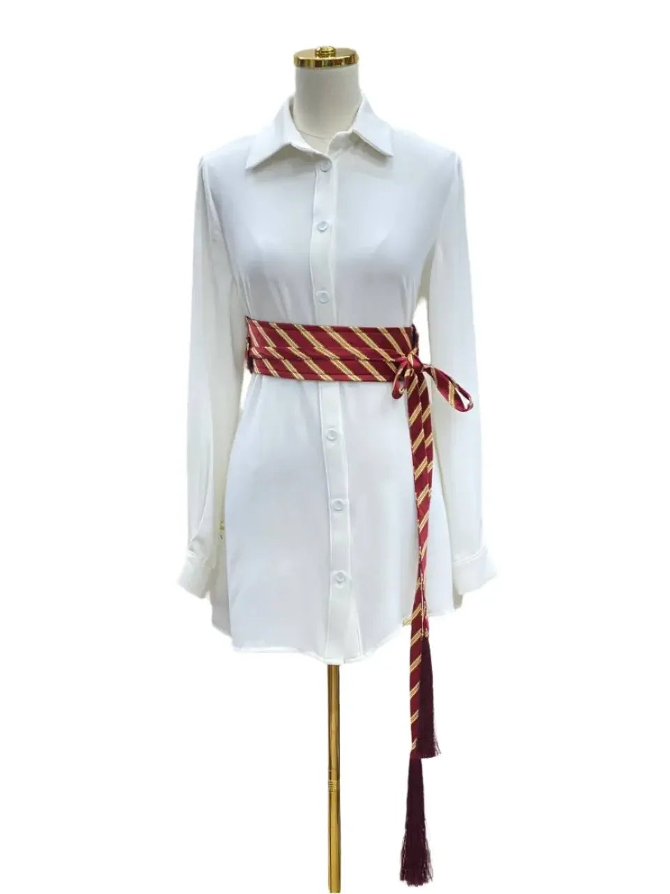 Embroidered kashmir belt in red and gold stripes tied around white shirt dress by Palestinian Elegance