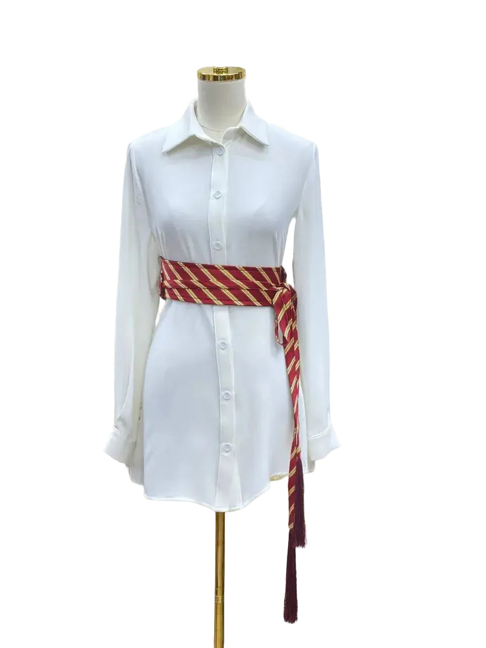 White long sleeve shirt styled with a red and gold embroidered kashmir belt around the waist