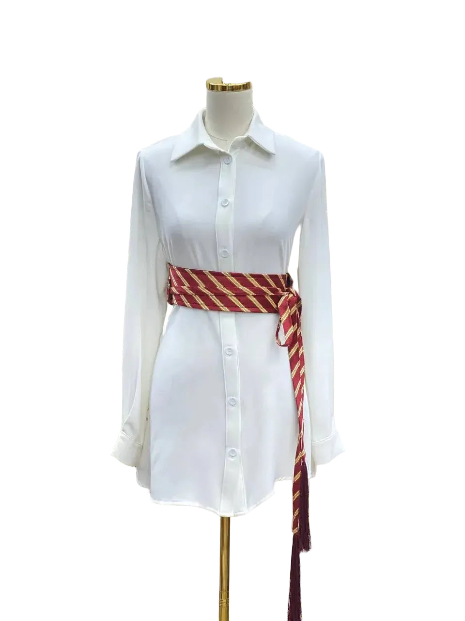 White button-down shirt dress styled with a red and gold embroidered kashmir belt by Palestinian Elegance