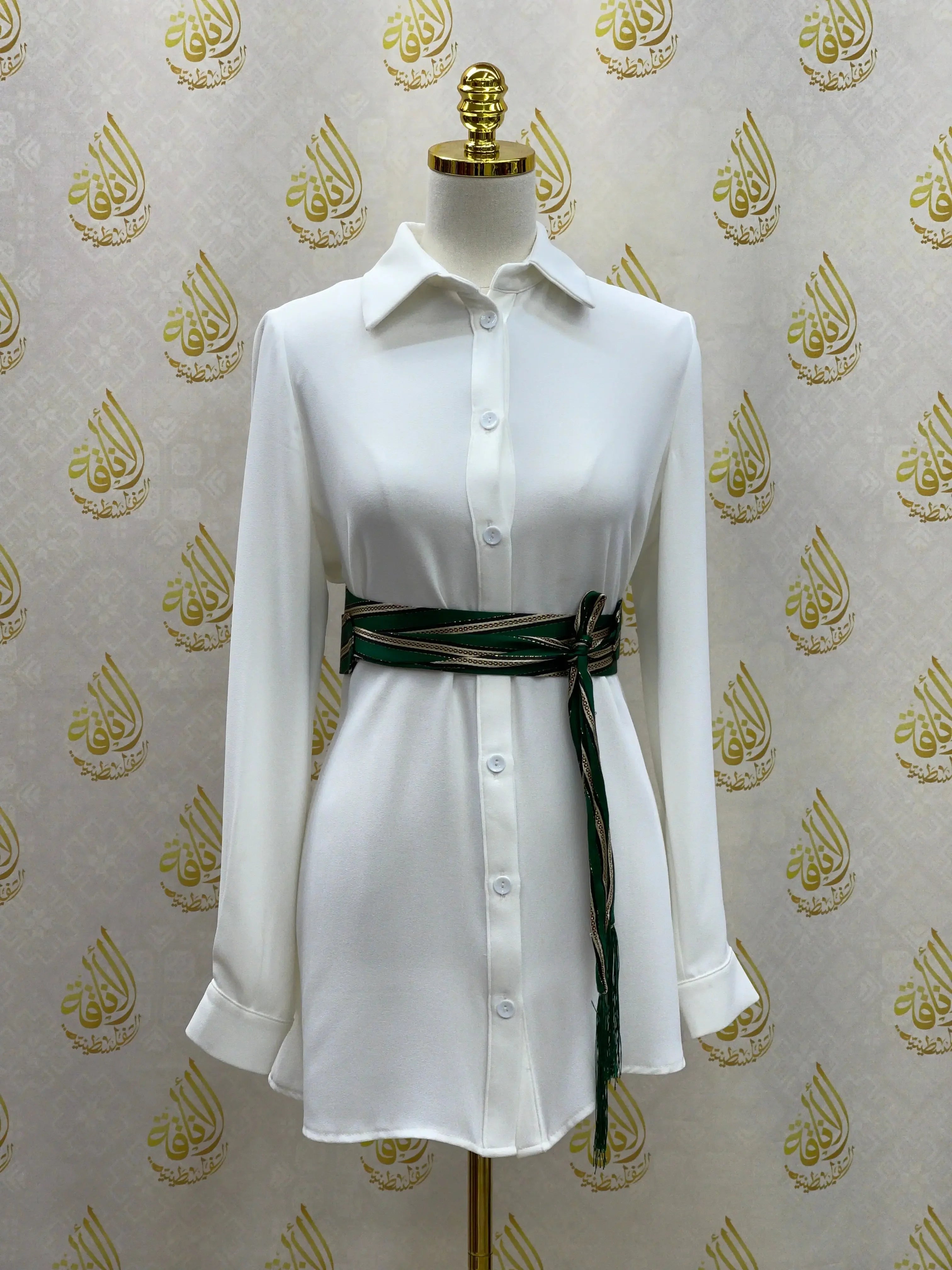 White long sleeve dress styled with Palestinian Elegance embroidered saya belt tied at the waist