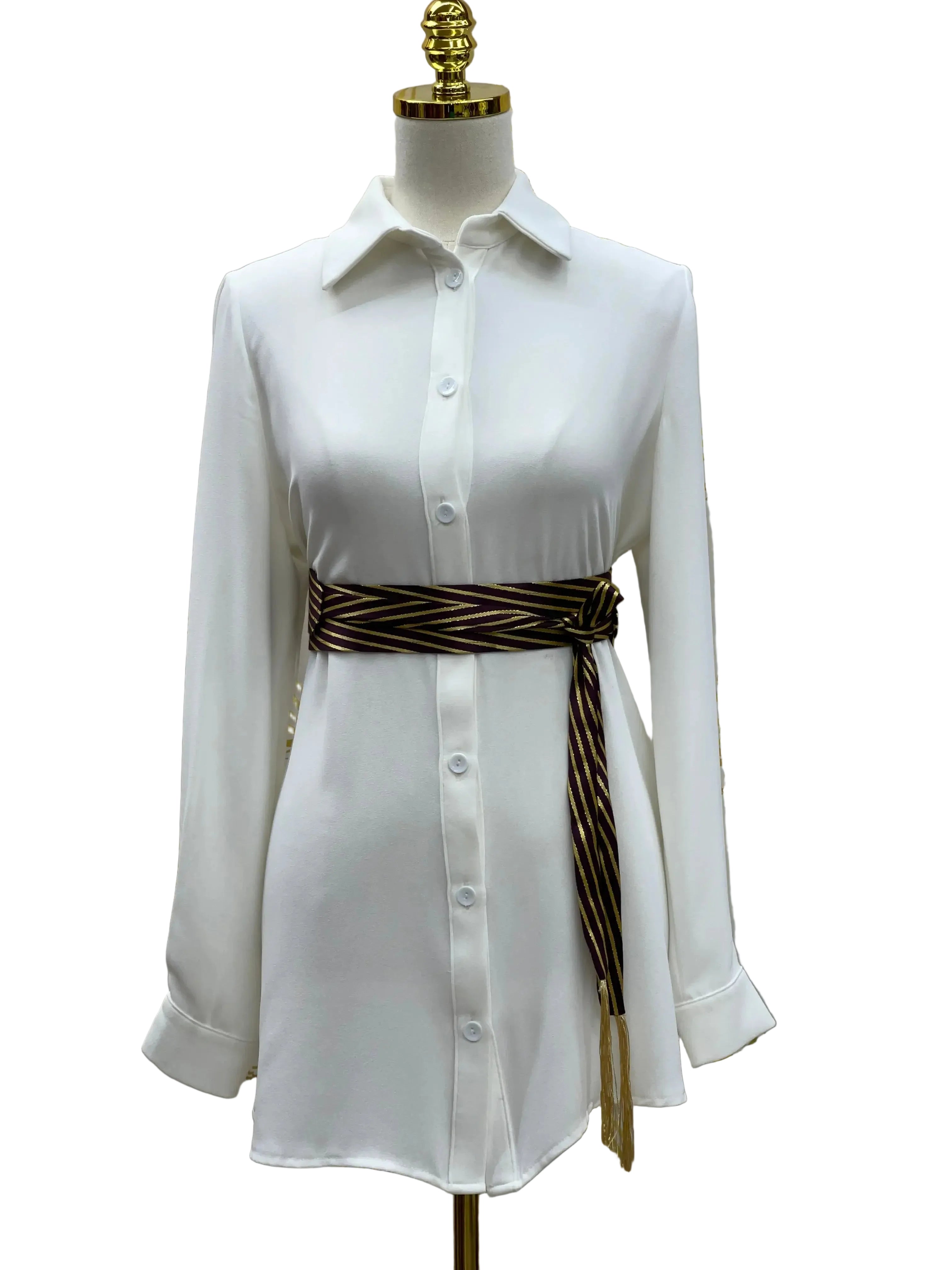 White button-up shirt dress styled with a Palestinian Elegance embroidered saya belt tied at the waist