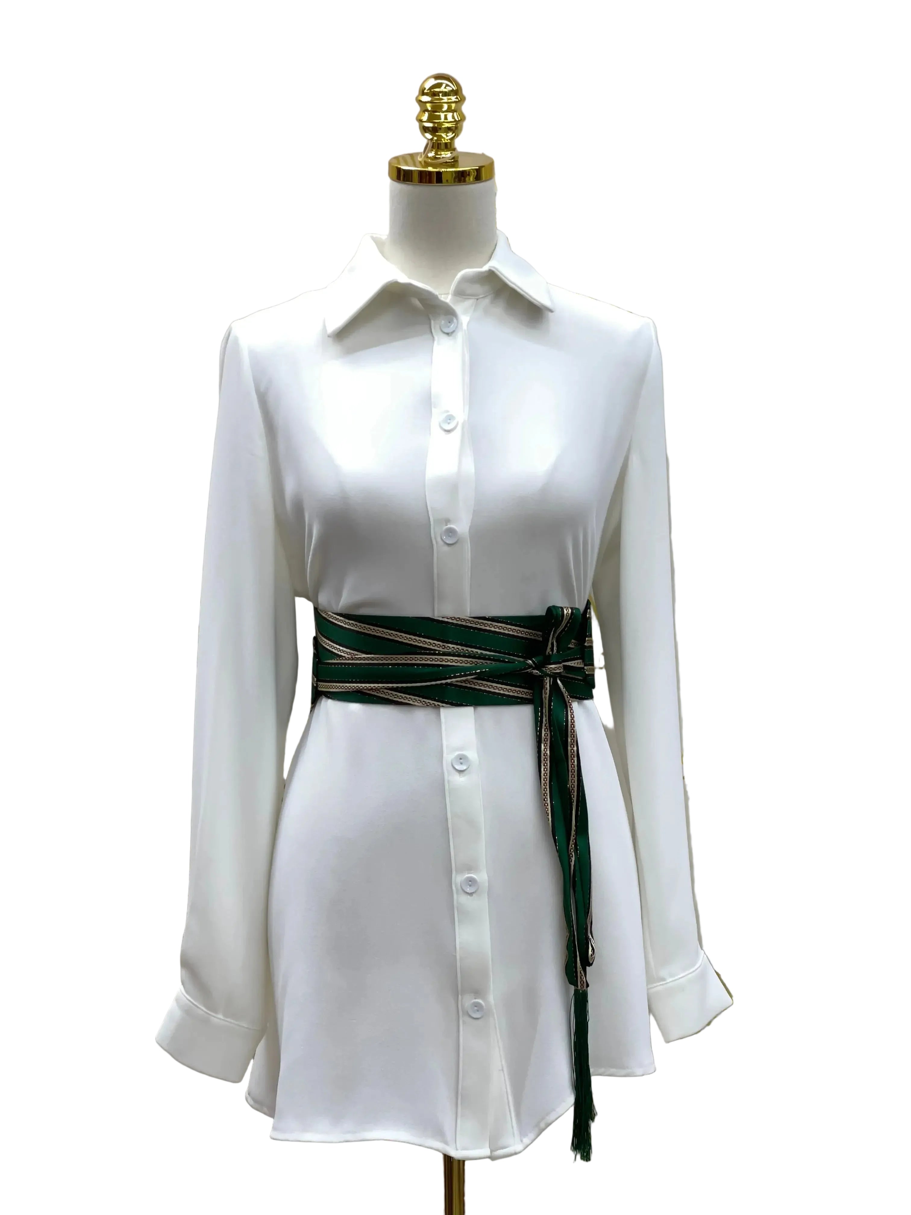 Embroidered waist belt for women in green and black wrapped around white button-down dress