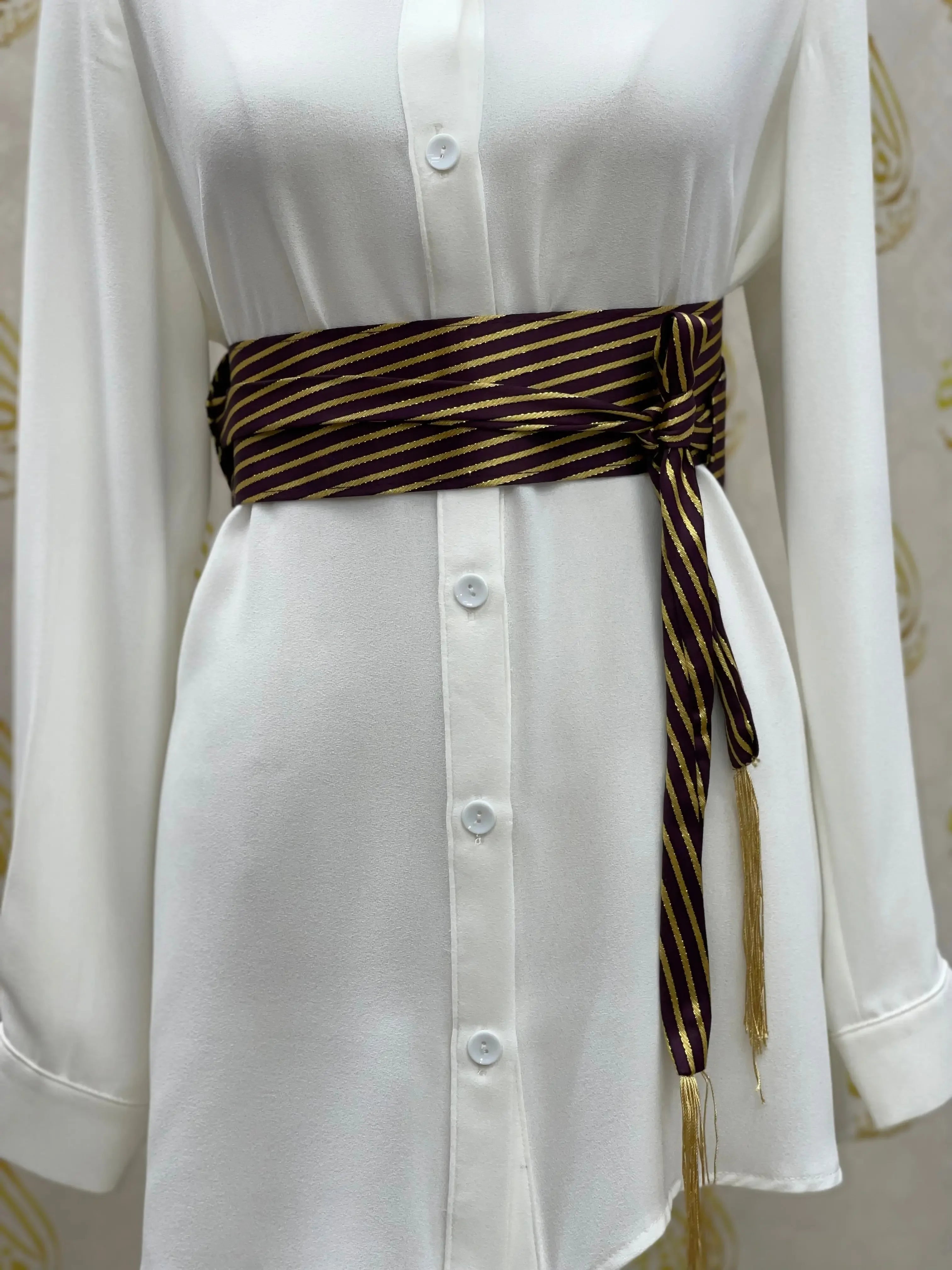 Palestinian Elegance embroidered waist belt for women in dark striped fabric tied over white dress