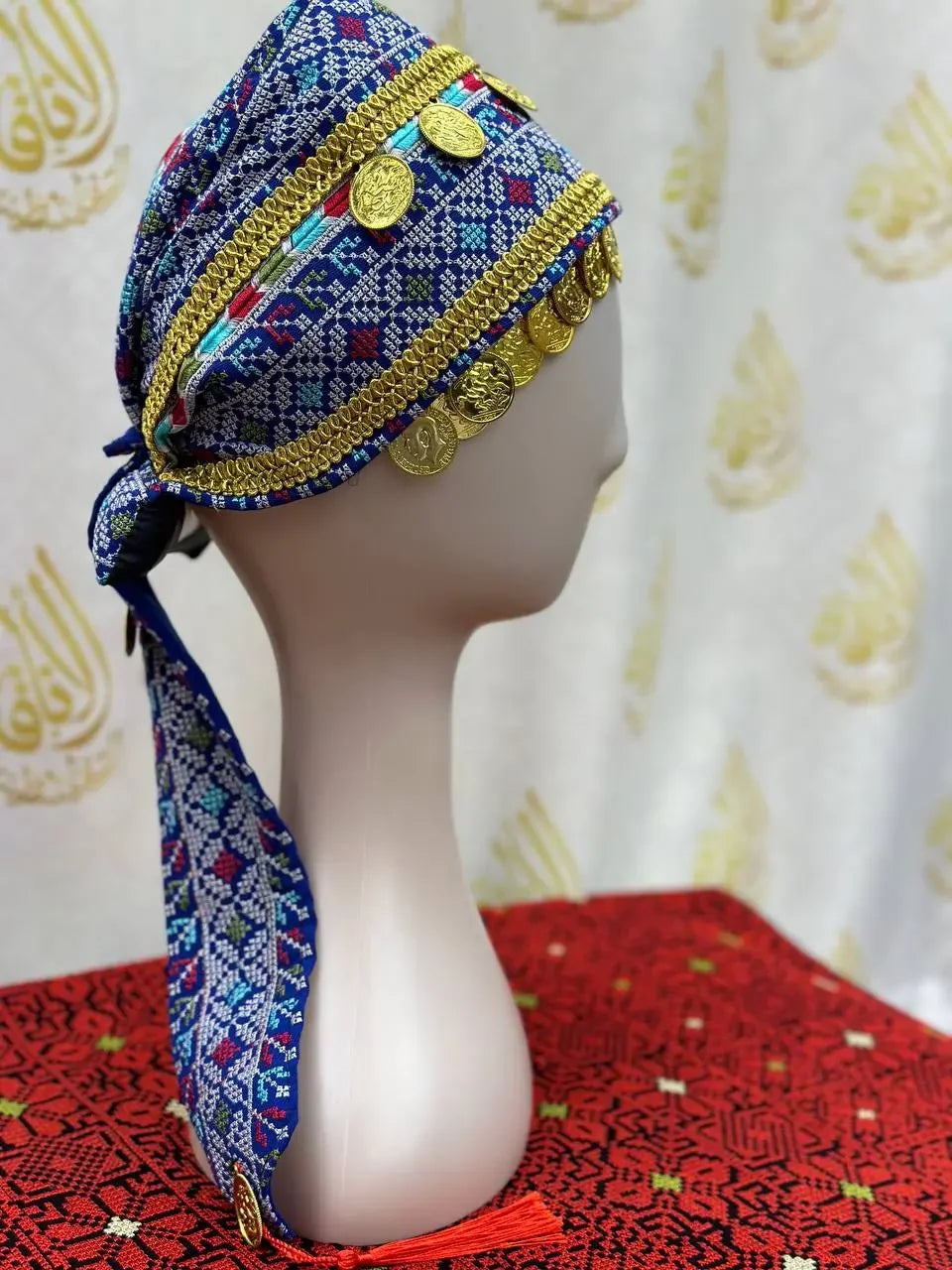 Palestinian Elegance kids tatreez headpiece with blue embroidery and gold coin accents on a mannequin