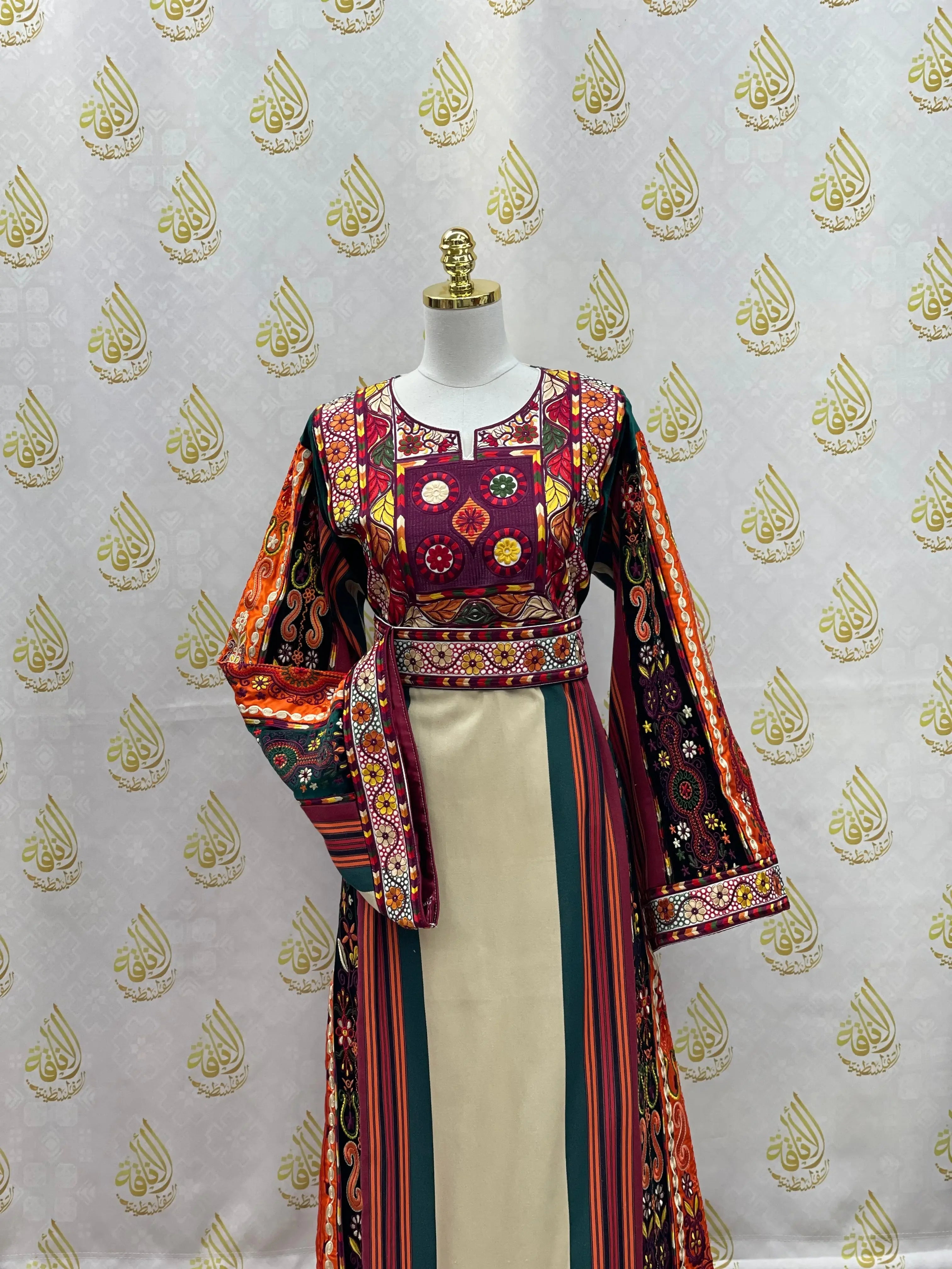 Palestinian embroidered thoub dress with colorful traditional patterns on mannequin
