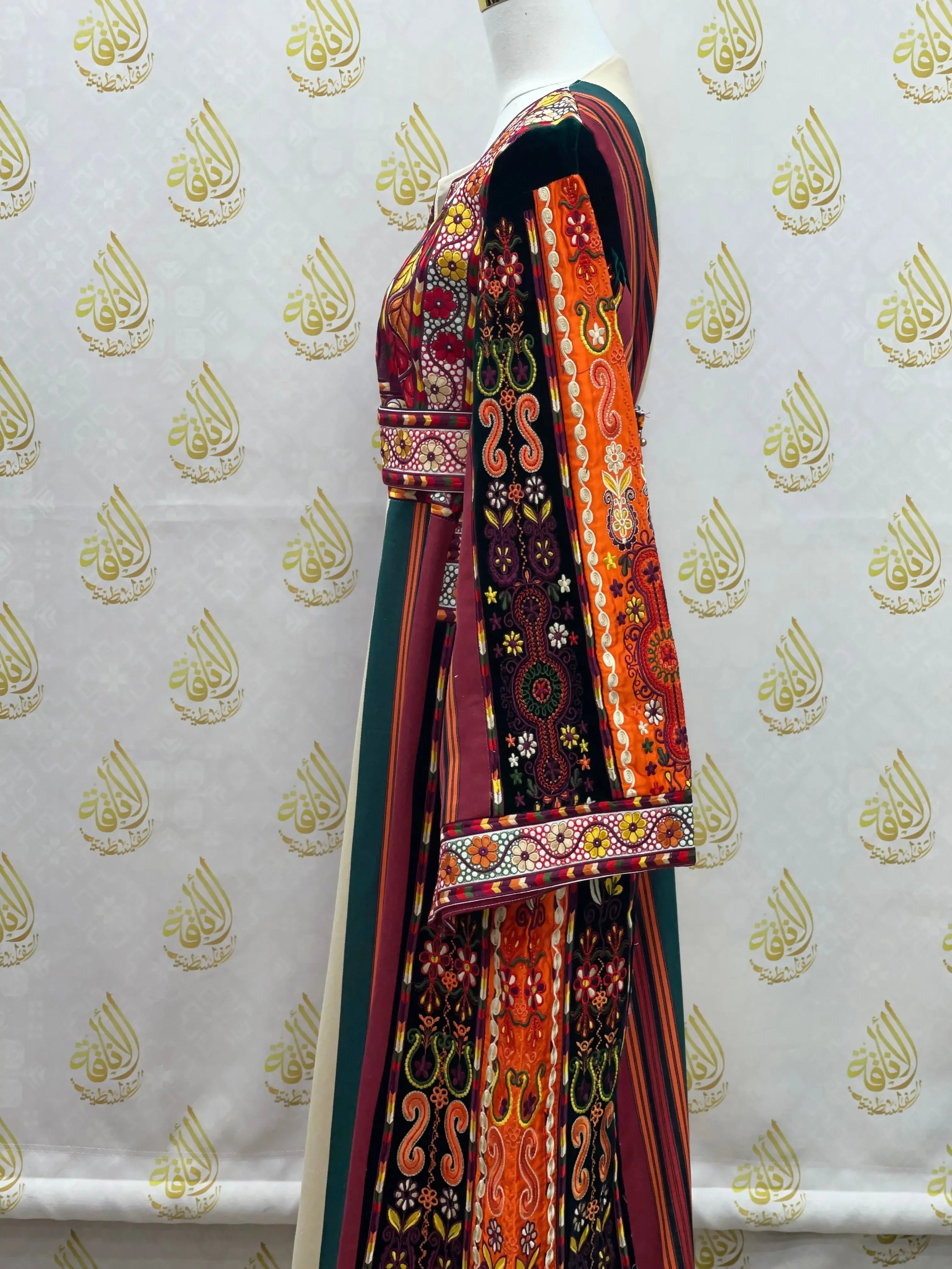 Palestinian embroidered thoub dress with colorful traditional embroidery and striped patterns by Palestinian Elegance