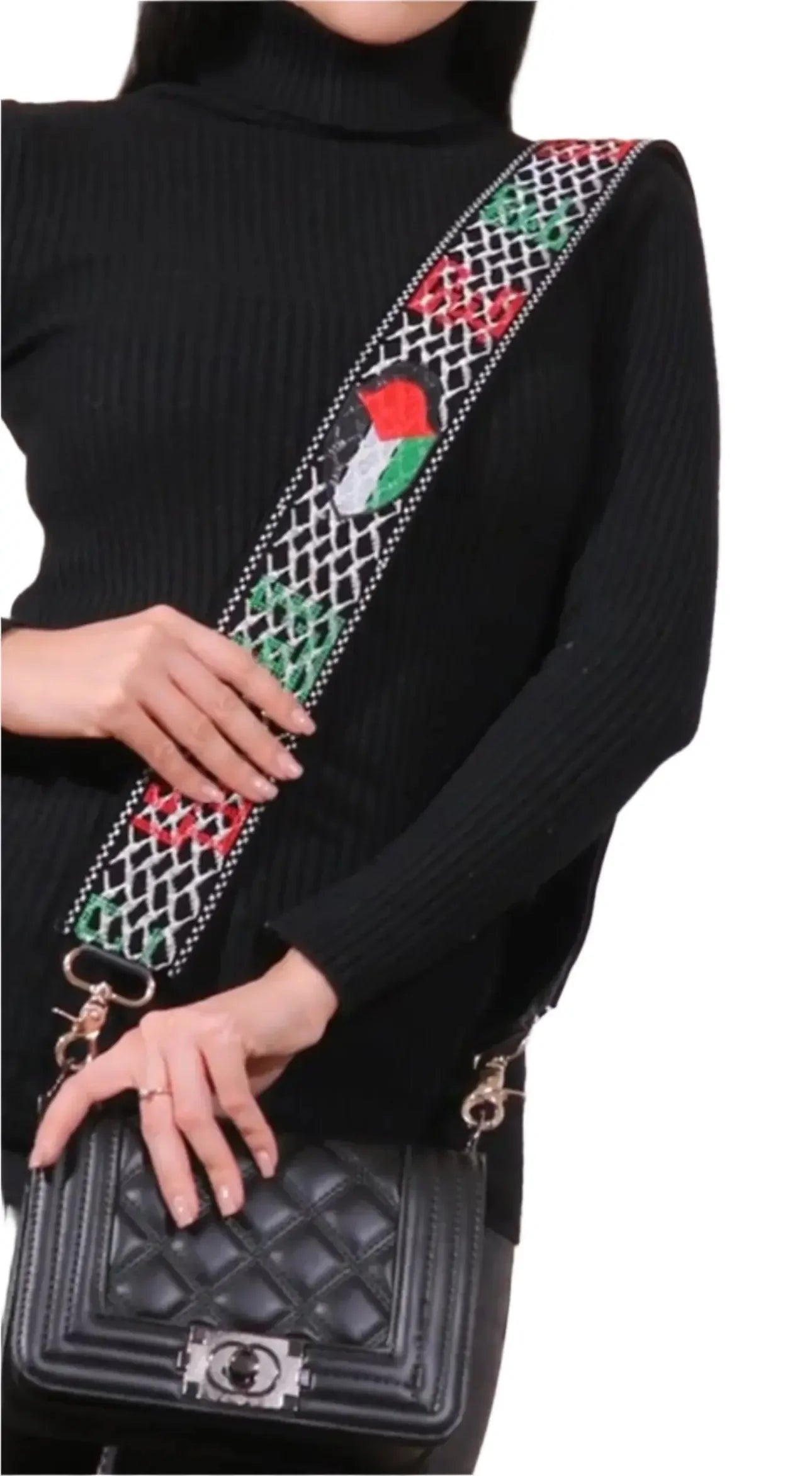 Palestinian purse strap replacement with embroidered red, green, and white patterns attached to black quilted purse