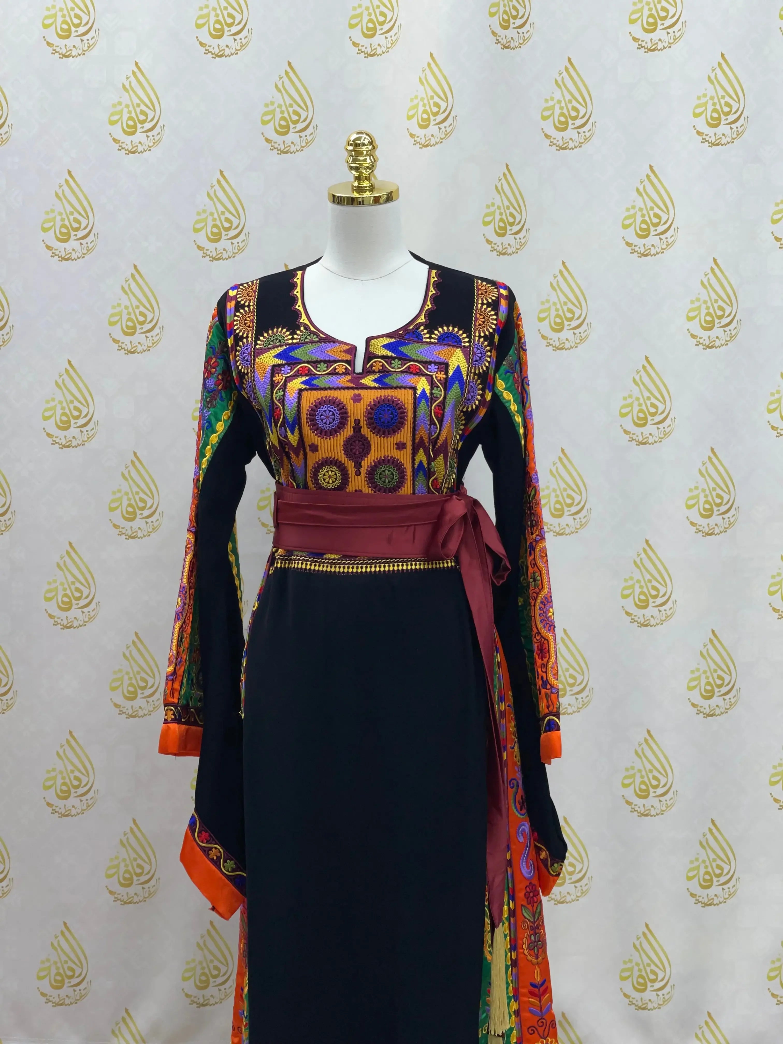 Palestinian Elegance embroidered long black dress with colorful traditional patterns and maroon waist sash