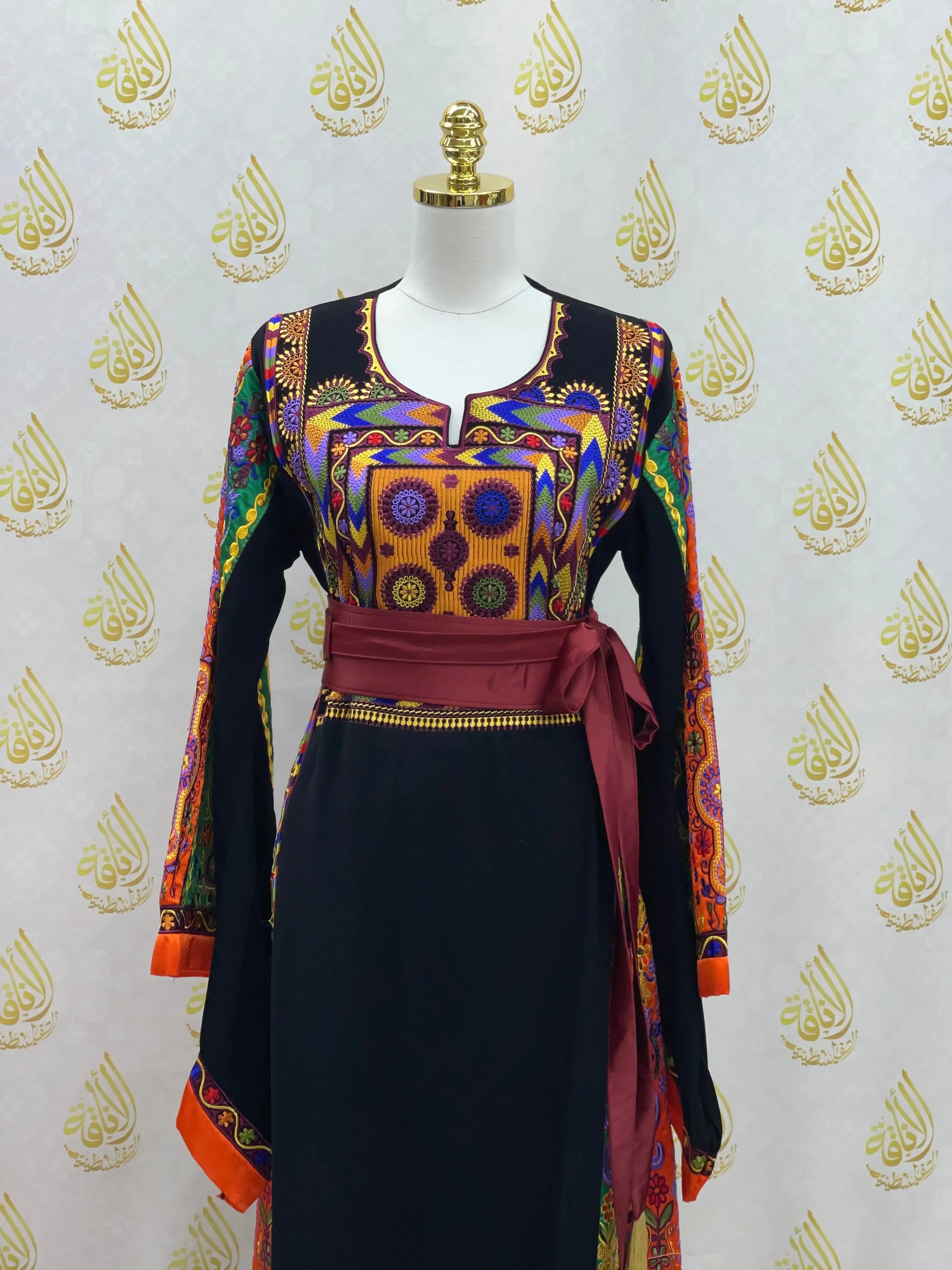 Palestinian Elegance black dress with colorful traditional embroidery and maroon waist sash