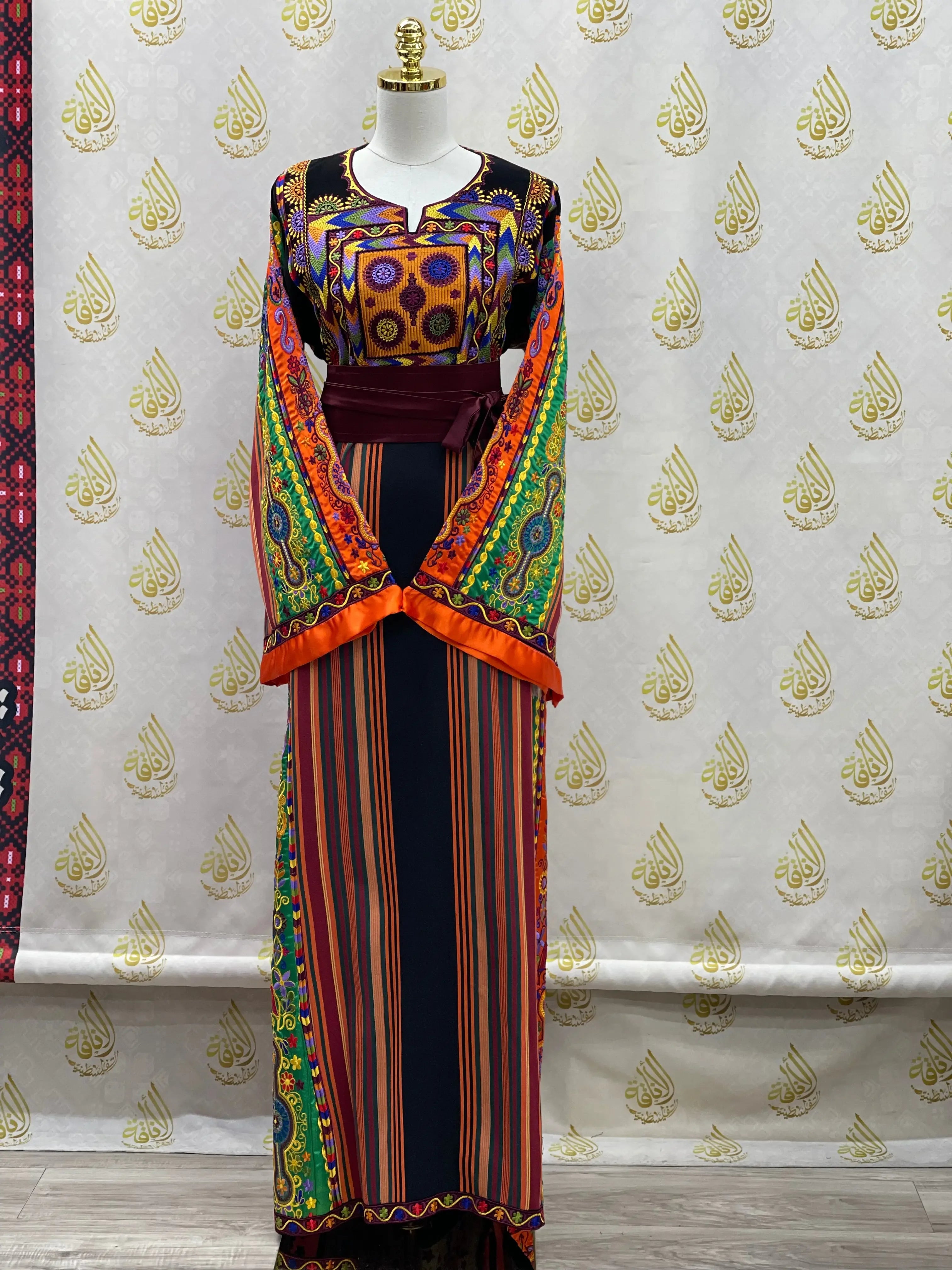 Palestinian Elegance embroidered traditional dress with colorful geometric and floral patterns on mannequin