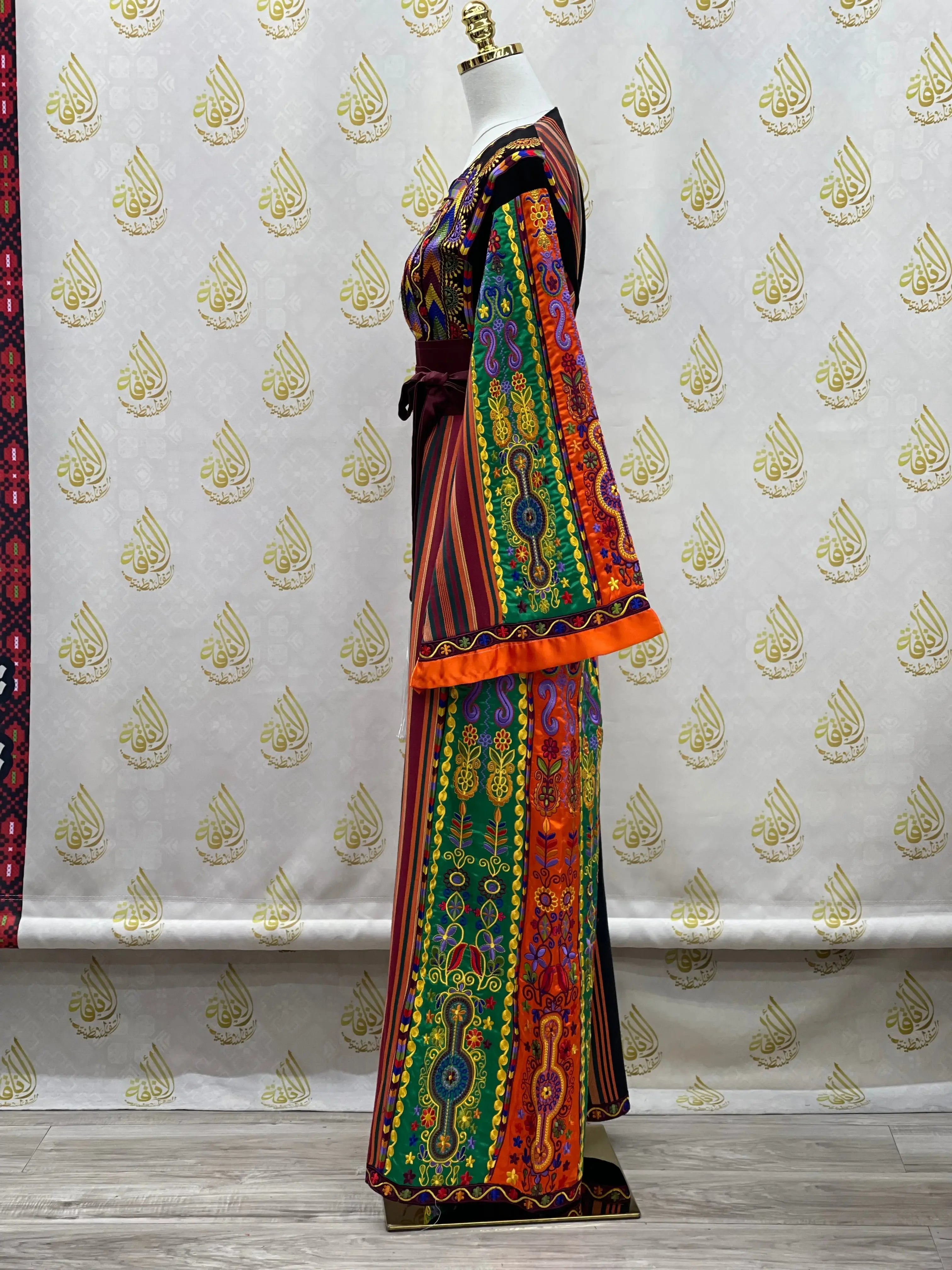 Palestinian Elegance embroidery dress with colorful traditional patterns and wide sleeves on mannequin