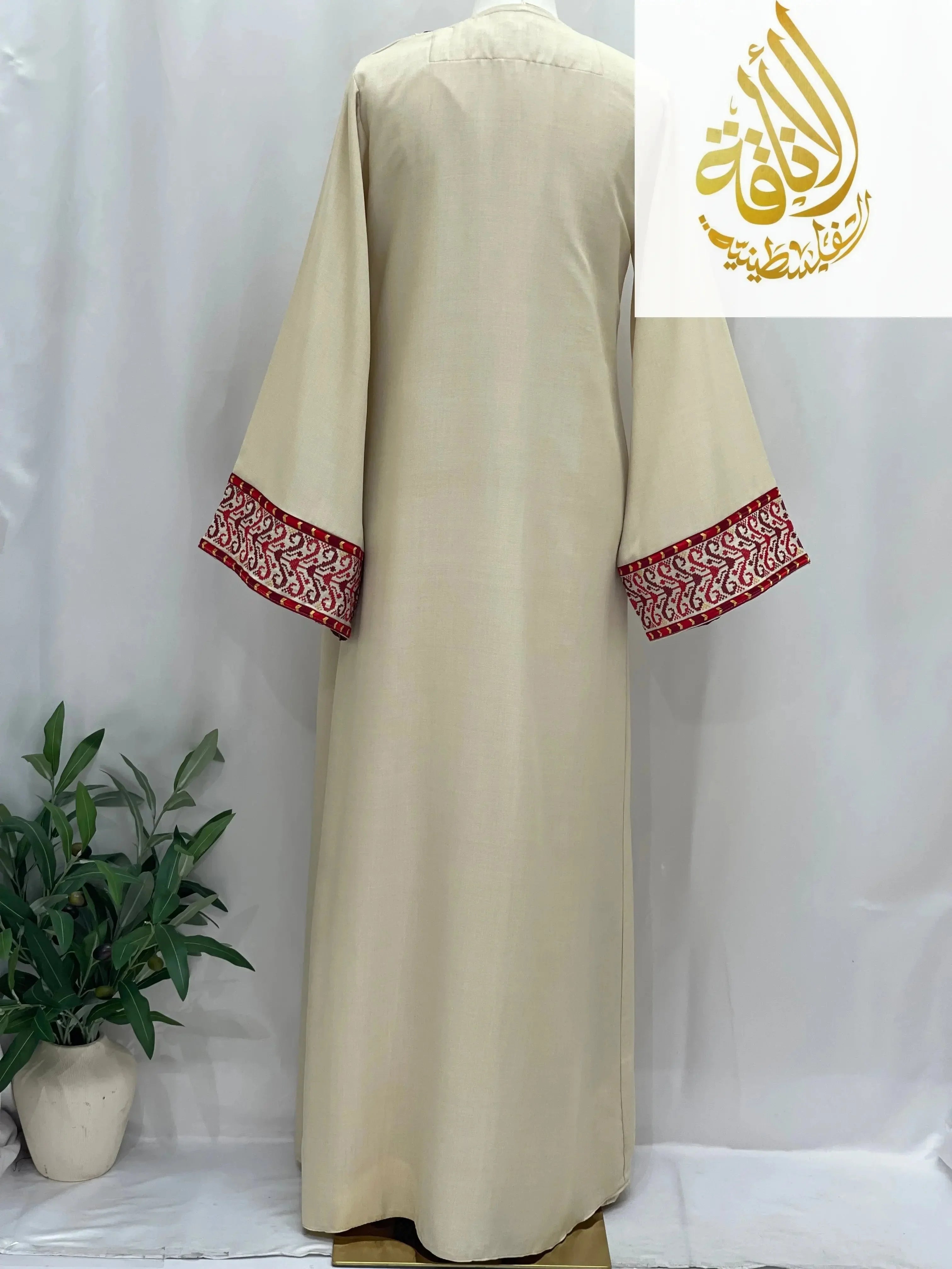 Back view of embroidered 3-piece Ahlam modest dress outfit by Palestinian Elegance with red detailed sleeve cuffs