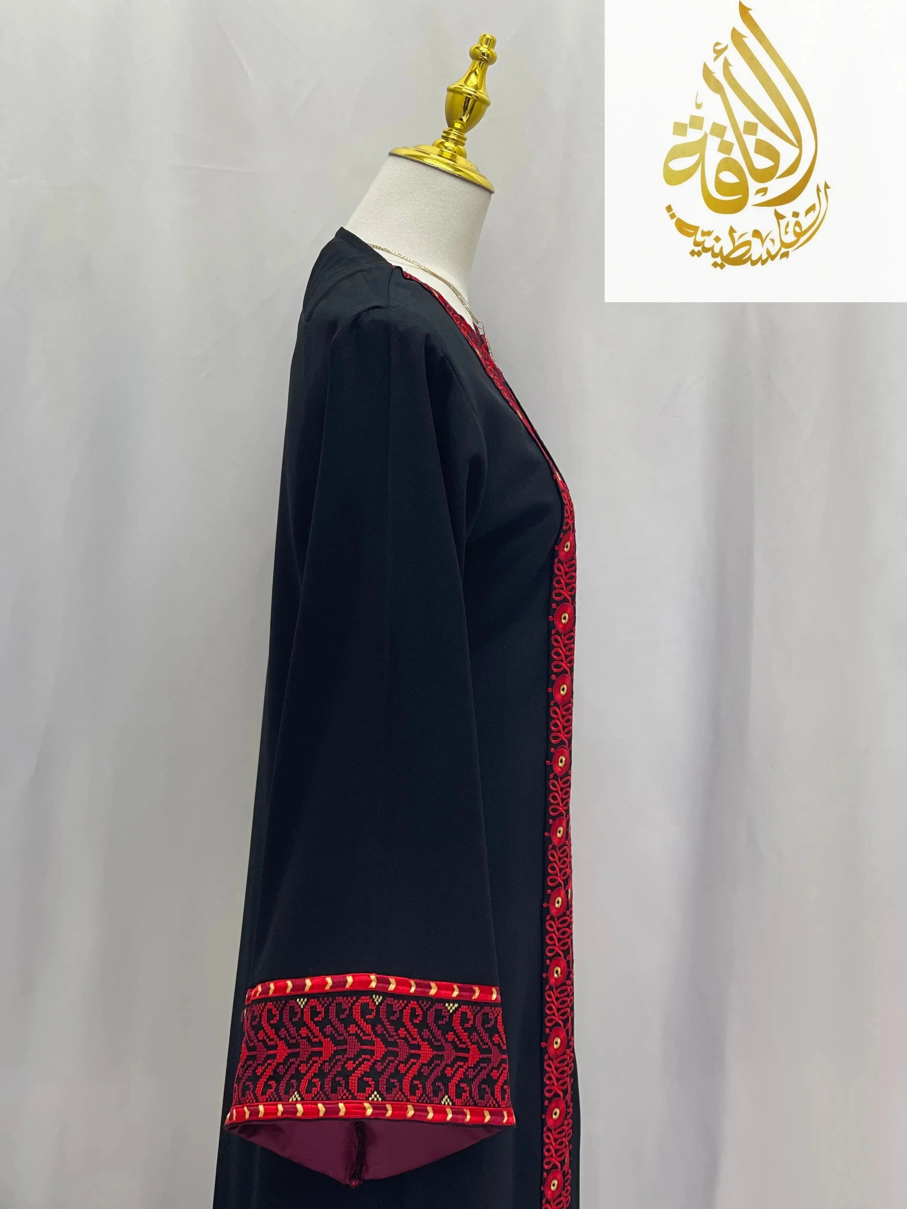 Palestinian Elegance embroidered 3-piece Ahlam modest dress outfit with red patterned trim on black fabric