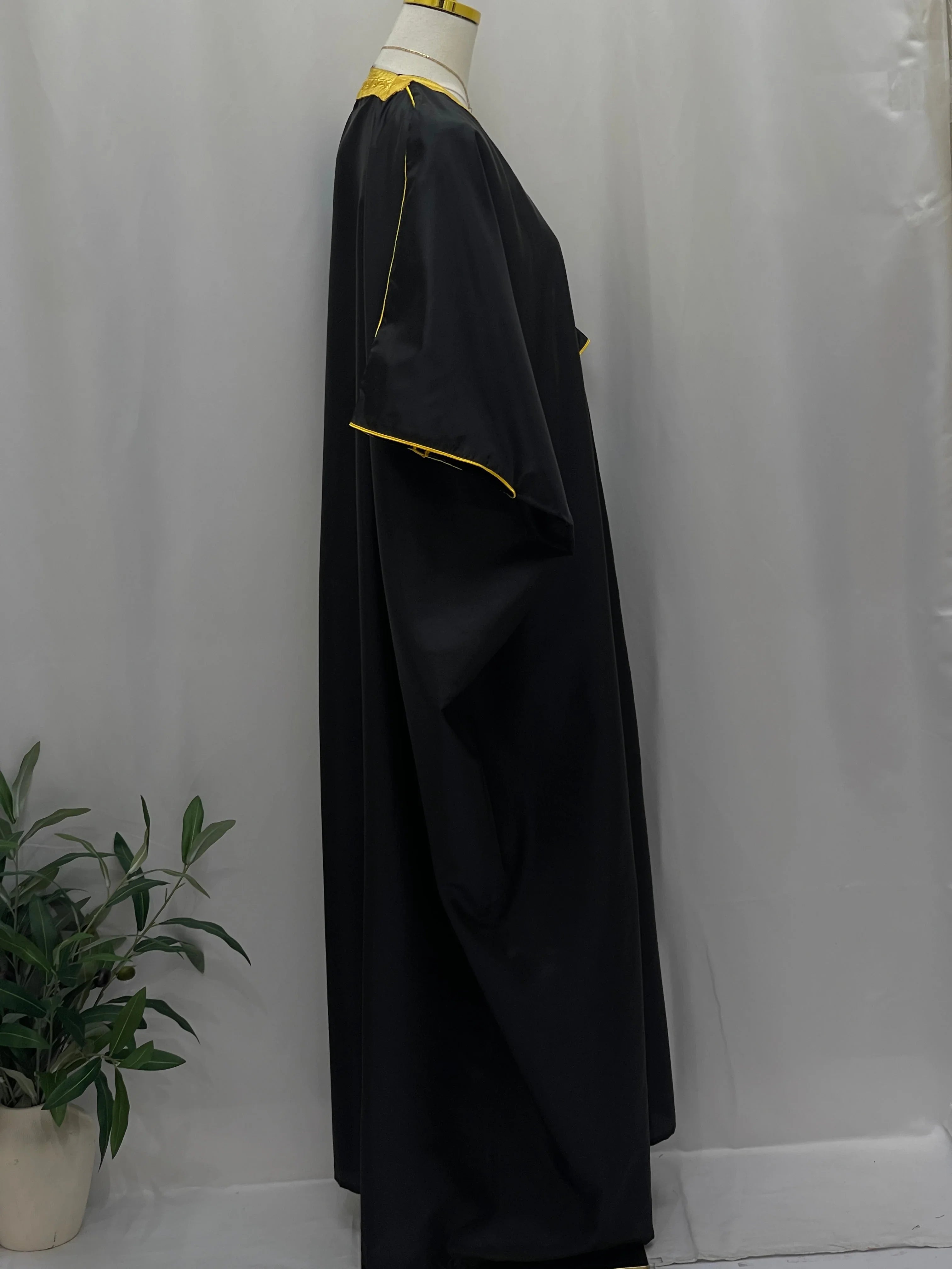 Mens Black Bisht with Golden Trim displayed on a mannequin against a neutral background