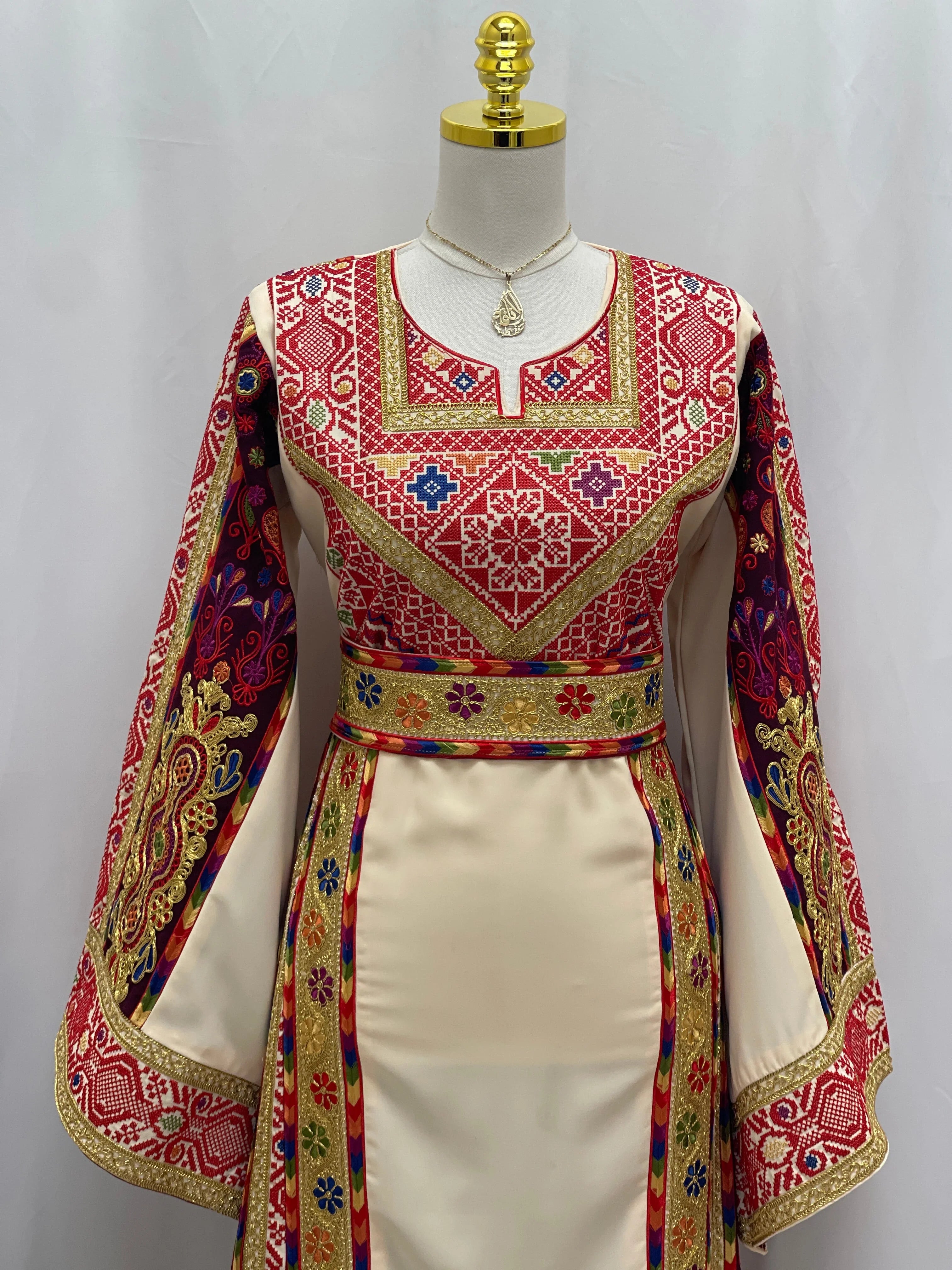 Al Kananiyyah Embroidered Thobe in cream with vibrant traditional patterns and flowing sleeves