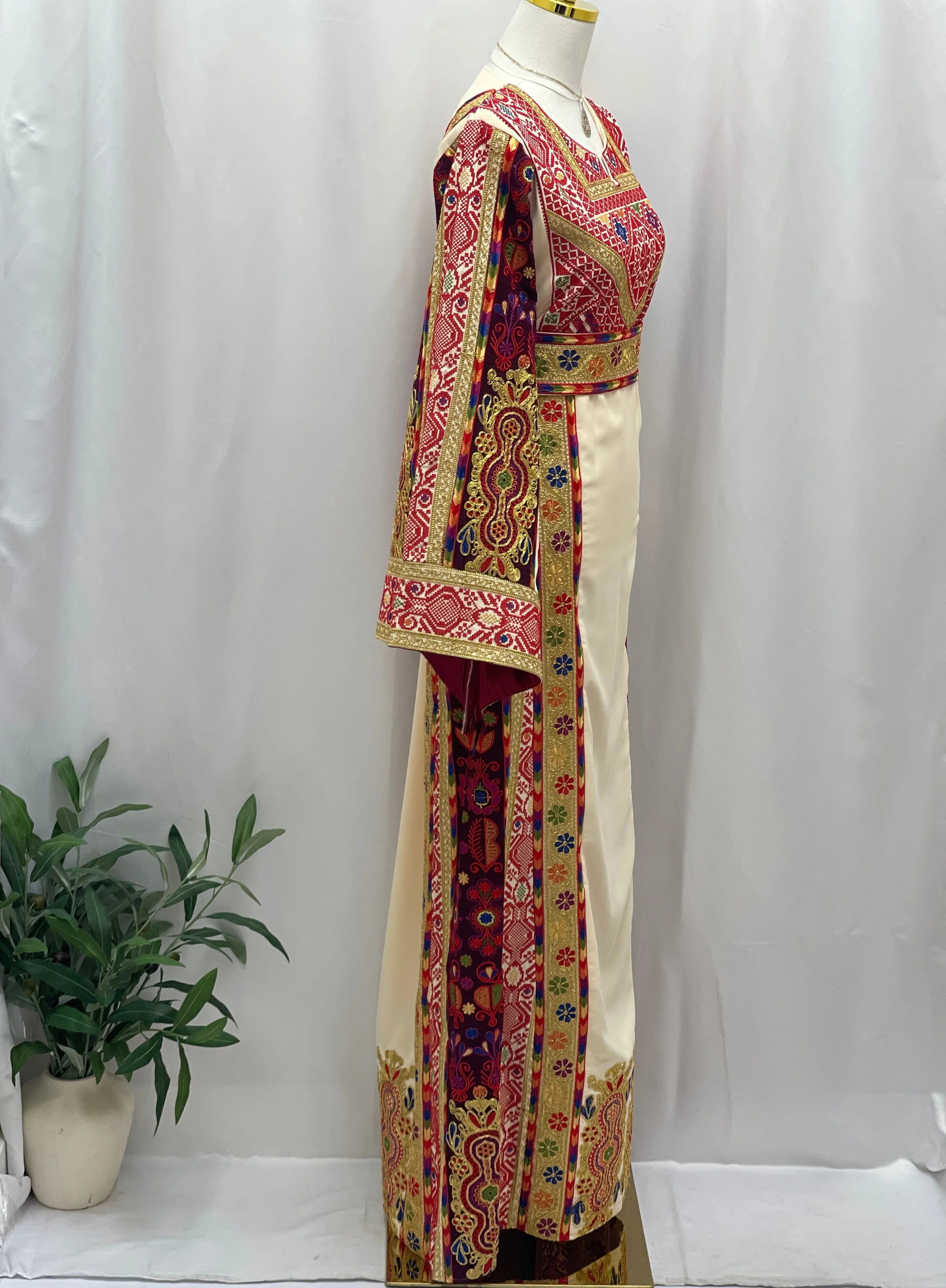 Al Kananiyyah Embroidered Thobe in cream with vibrant traditional embroidery and long flowing sleeves