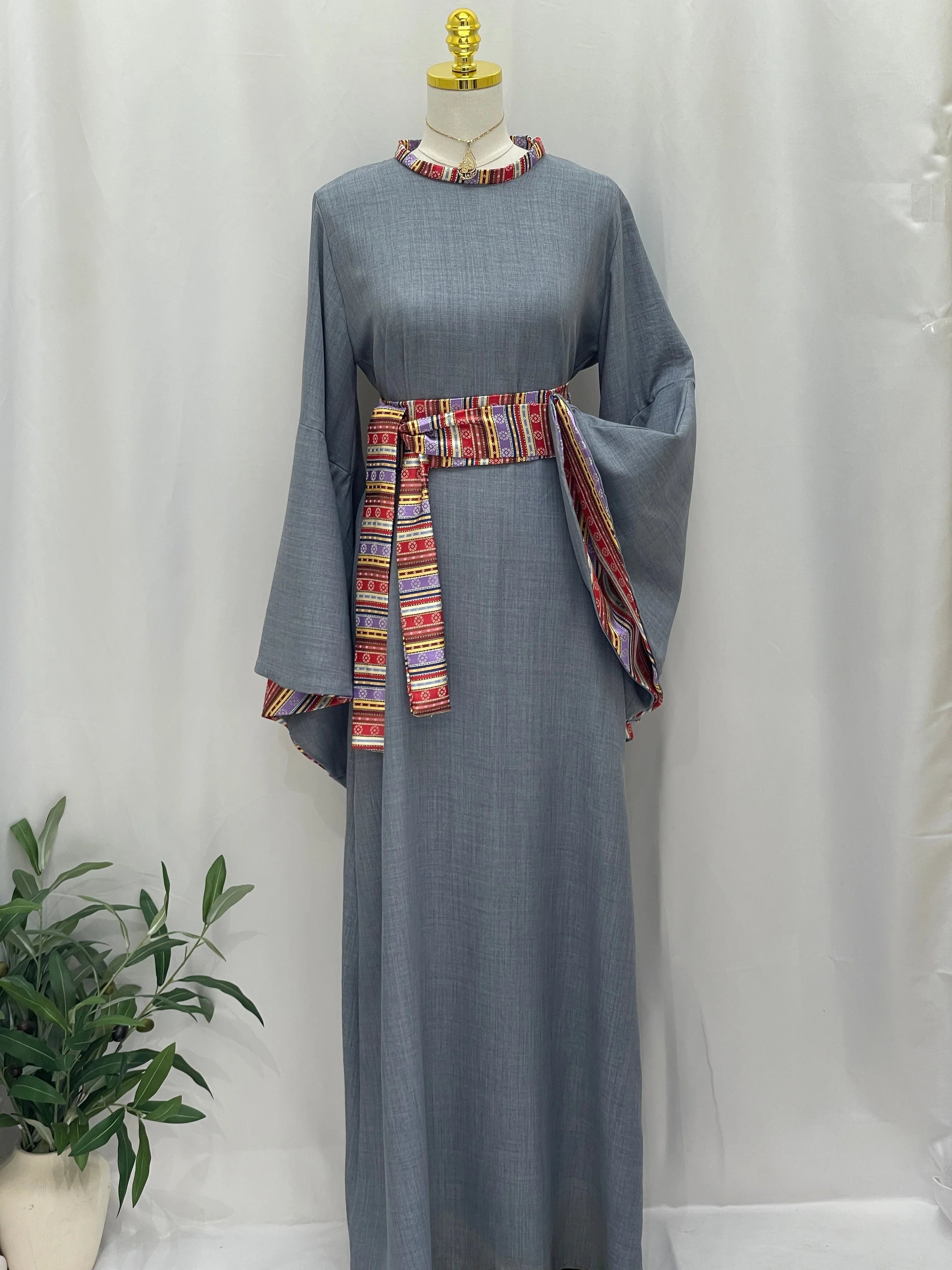 Elegant Al-Mais Thobe featuring intricate embroidery and a colorful waist belt for a stylish look