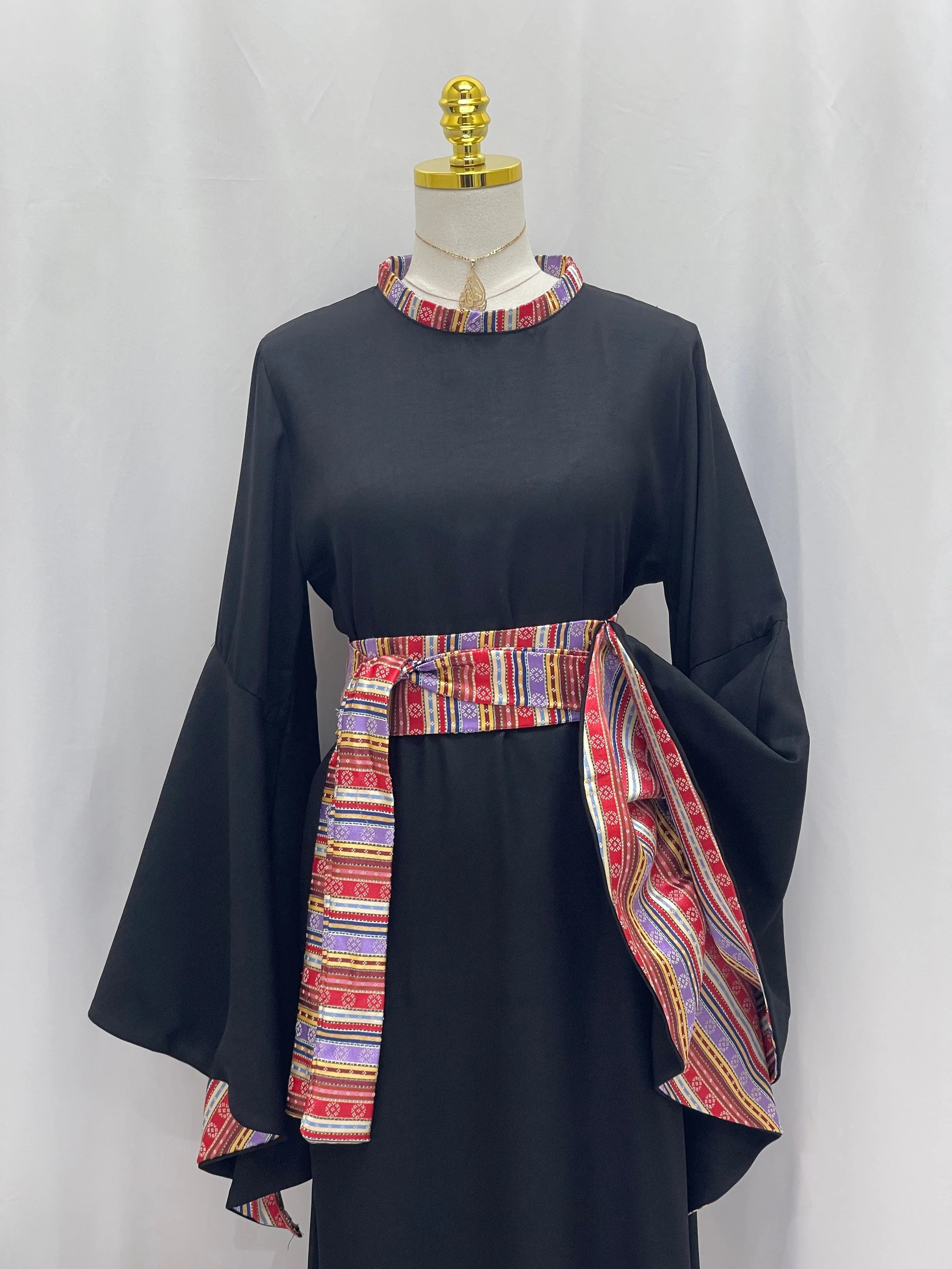 Elegant Al-Mais Thobe featuring bell sleeves and colorful embroidered belt for a stylish look