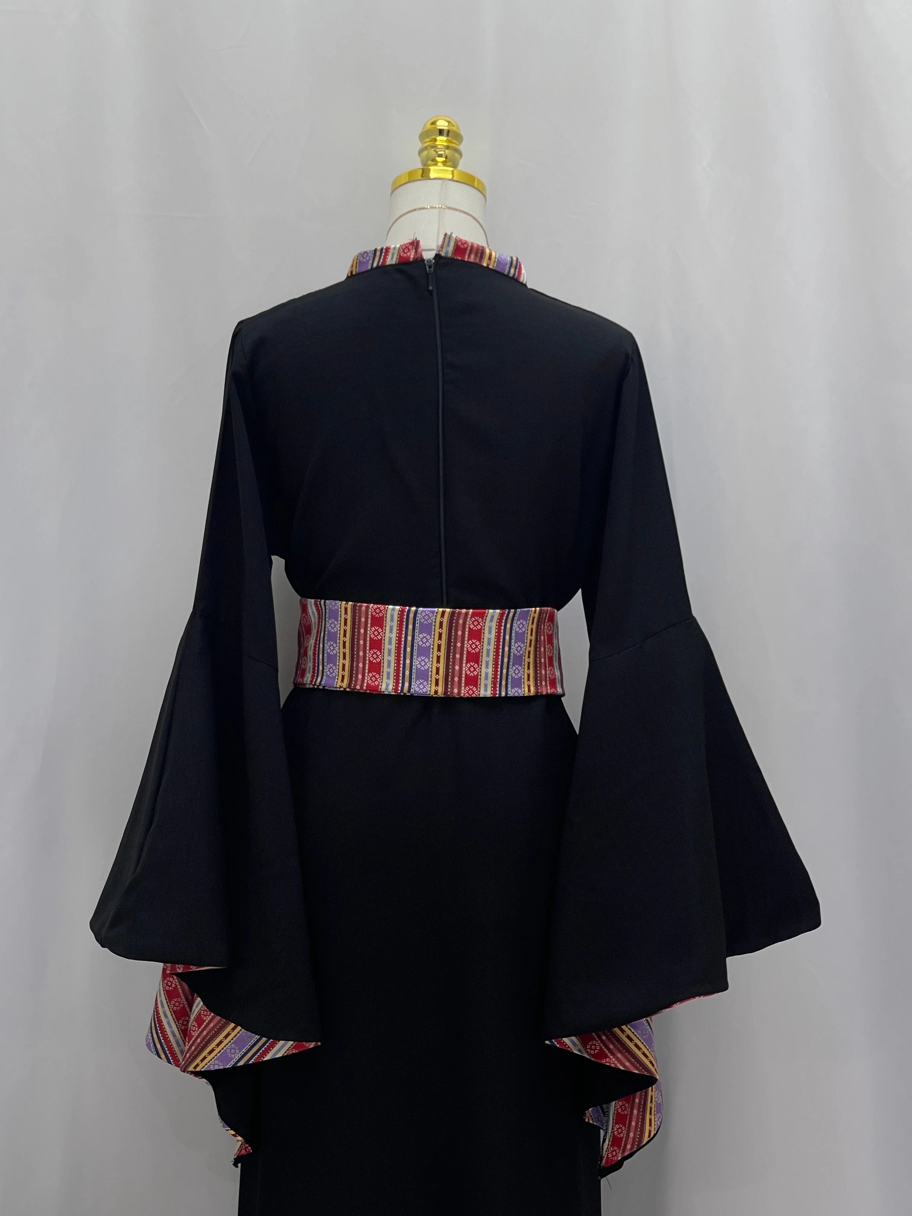 Back view of Al-Mais Thobe featuring embroidered accents and bell sleeves for a traditional look