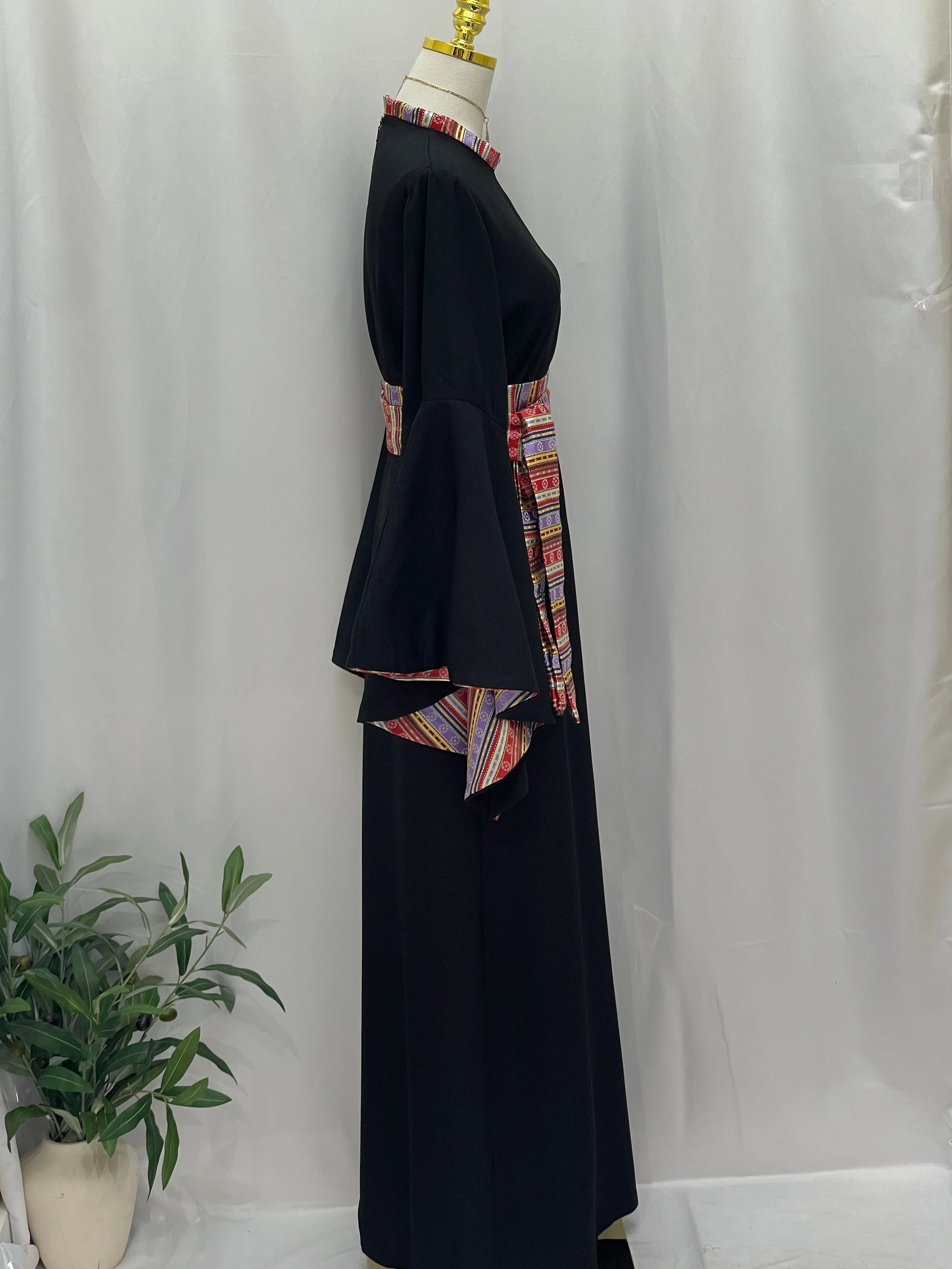Side view of the Al-Mais Thobe featuring elegant embroidery and a colorful waistband for stylish comfort