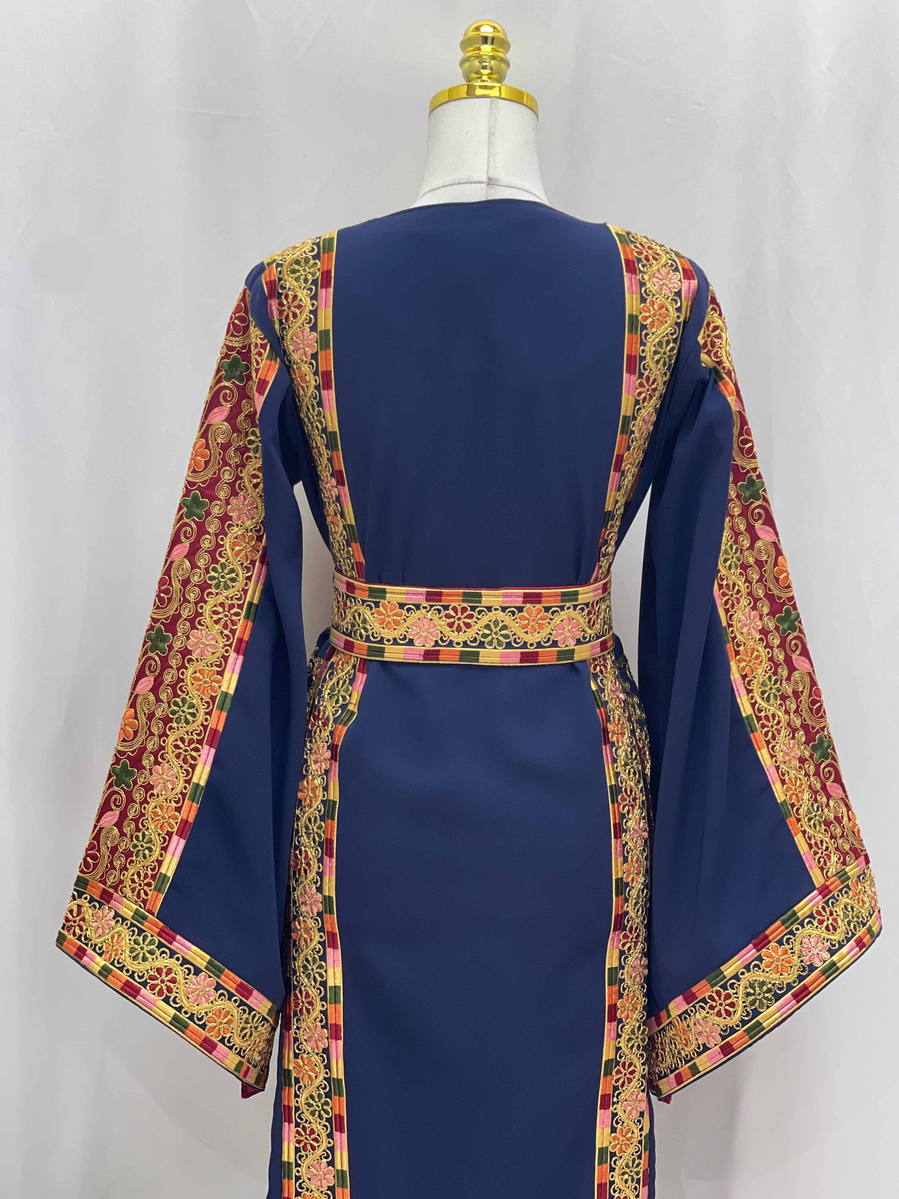 Back view of Al-Qasab Malaki Thobe with vibrant embroidered patterns and elegant sleeves