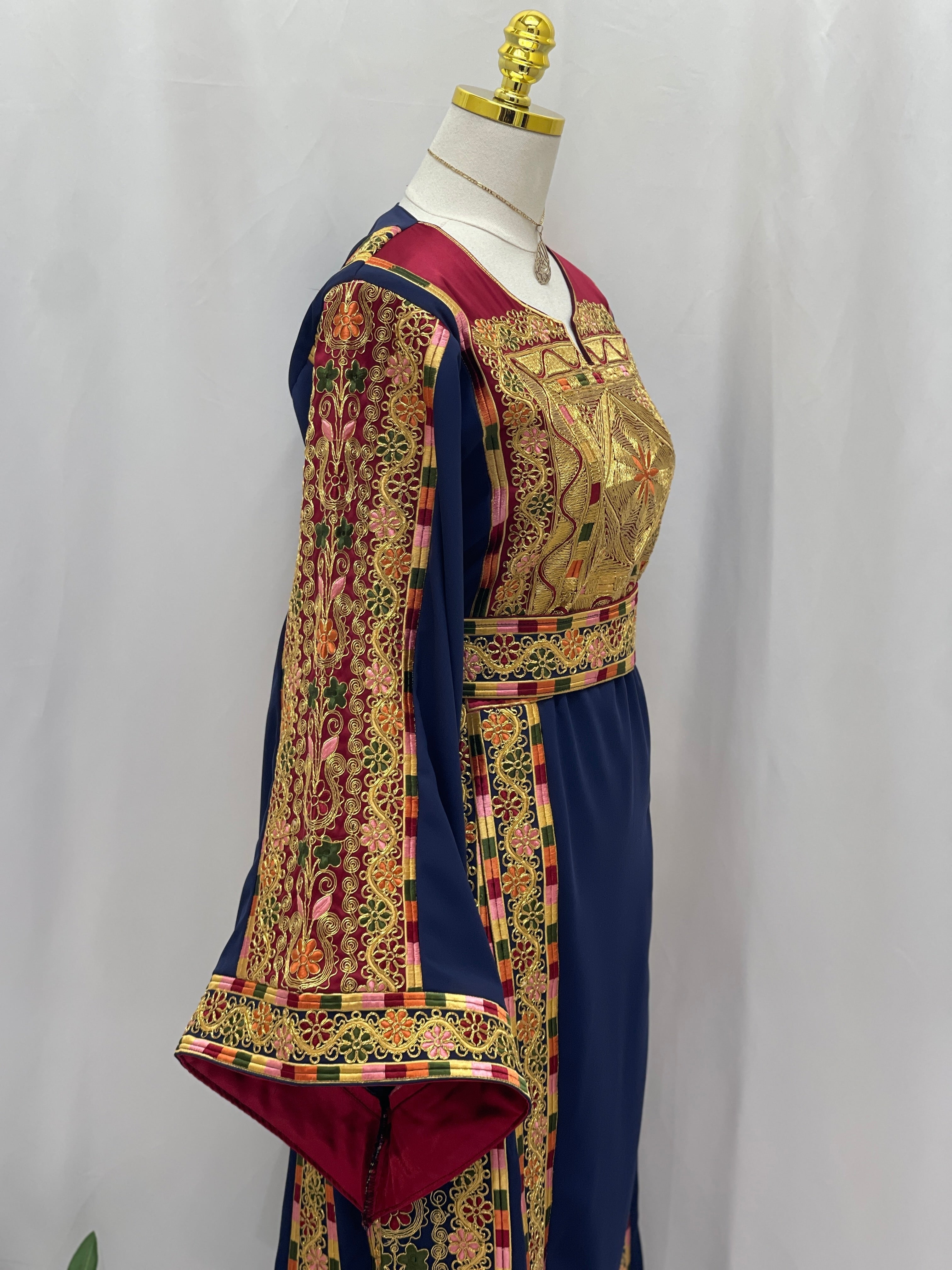 Elegant Al-Qasab Malaki Thobe with intricate embroidery and vibrant colors, showcasing traditional Palestinian design