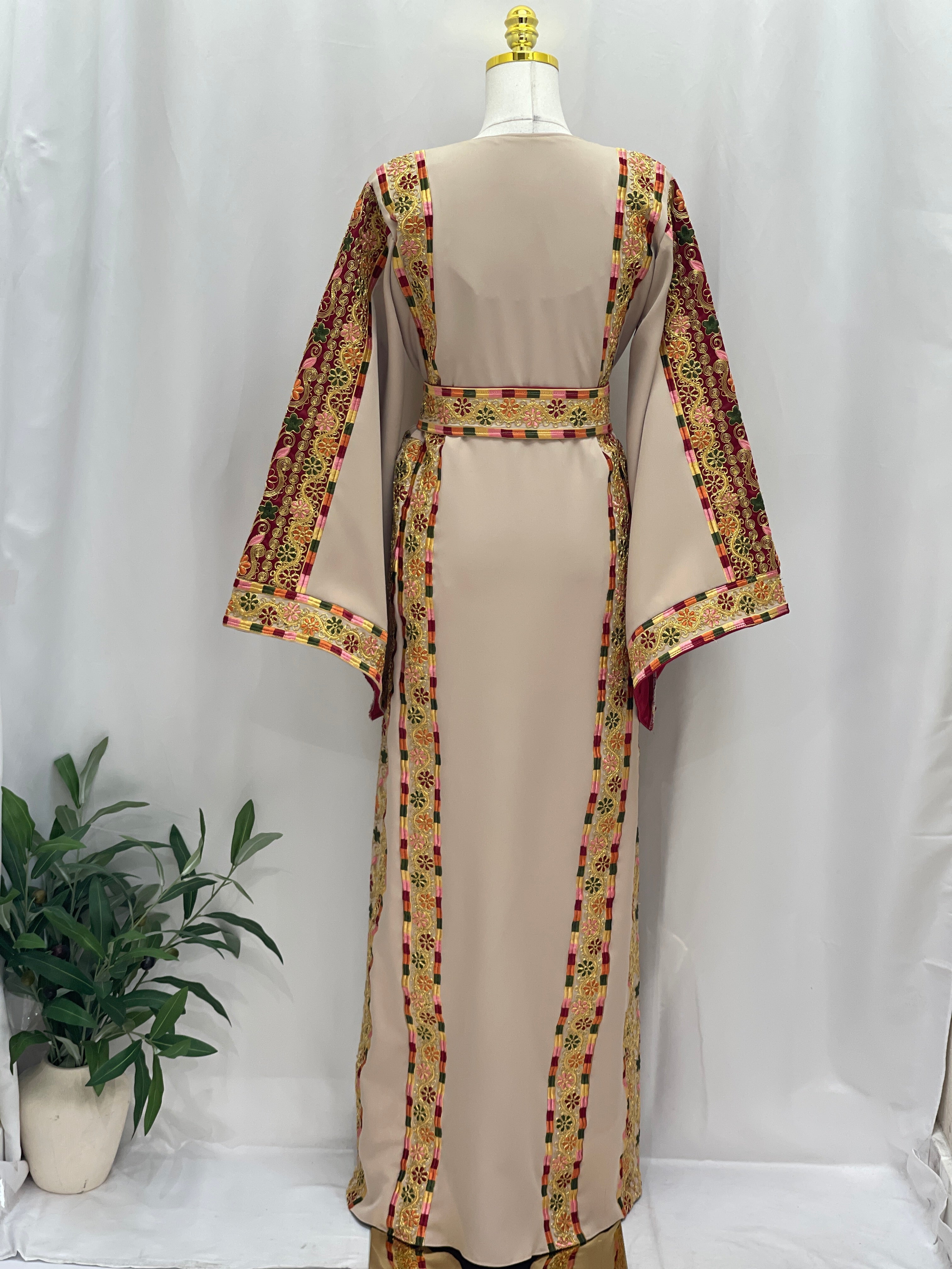 Back view of a beige Embroidered Al-Qasab Malaki Thobe with colorful floral trims and flowy sleeves