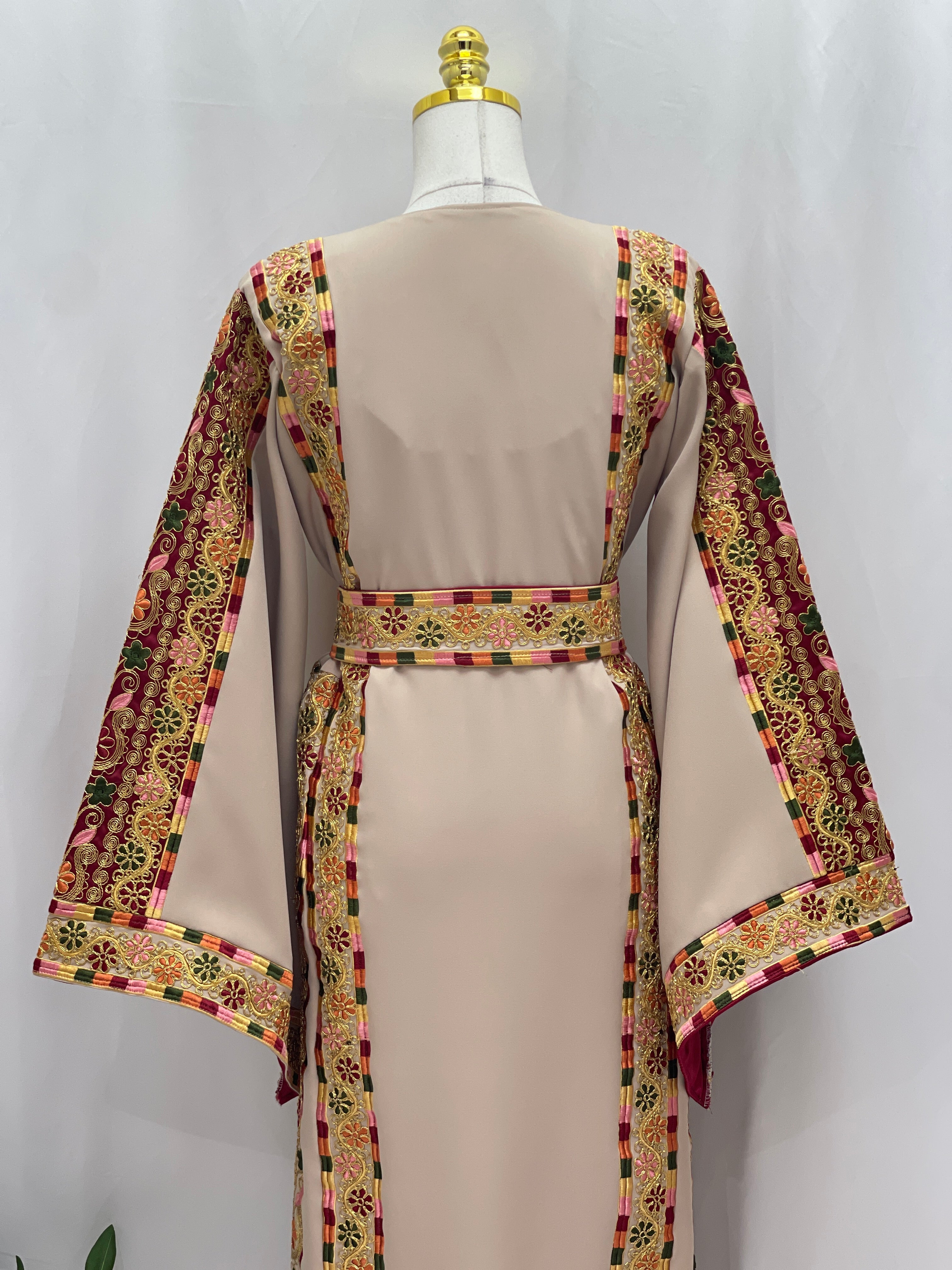 Back view of the Al-Qasab Malaki Thobe featuring colorful embroidered patterns on the sleeves and waist
