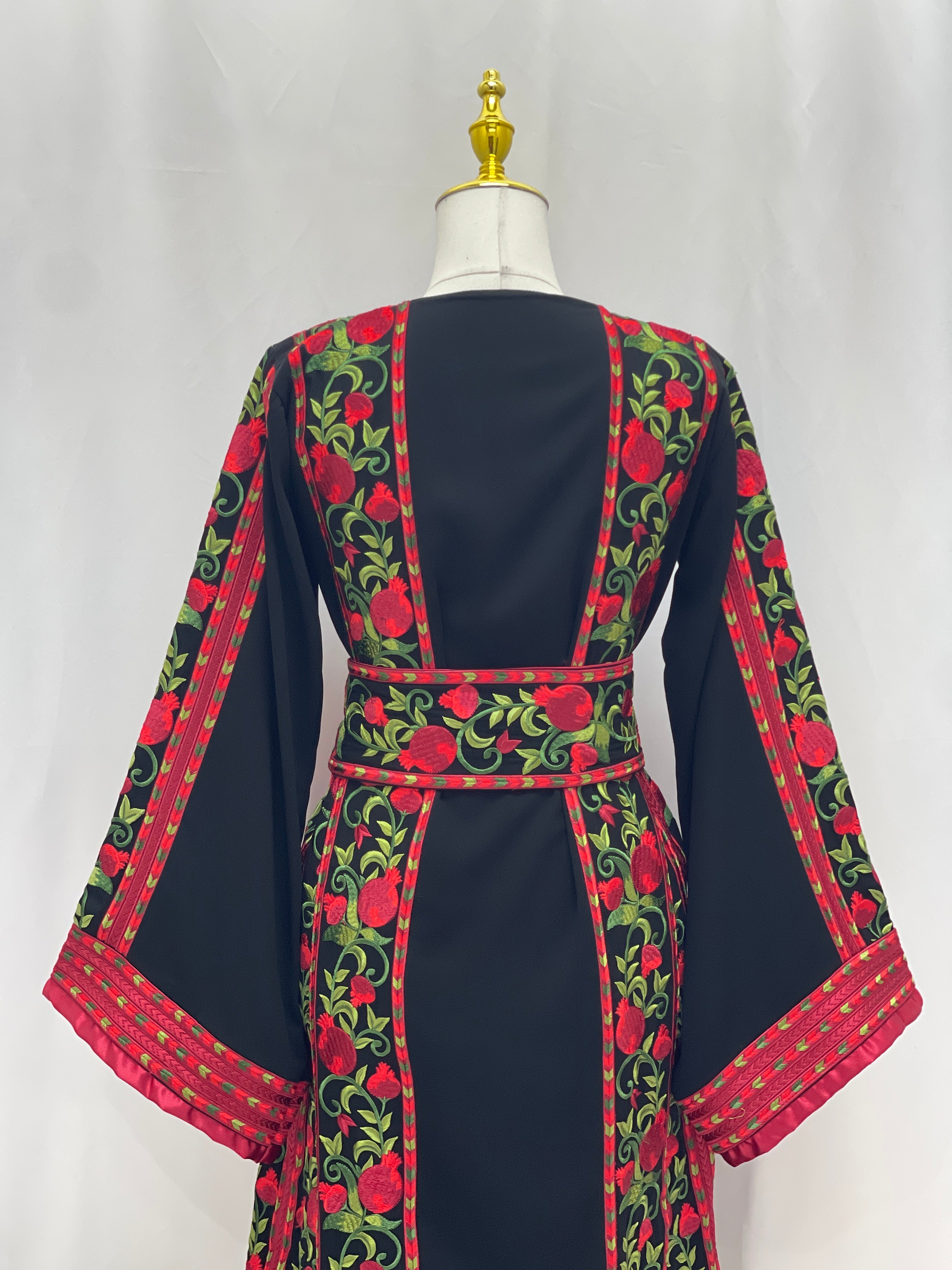 Palestinian Elegance Al Romana Pomegranate Embroidered Thoub with red and green floral embroidery  fabric
