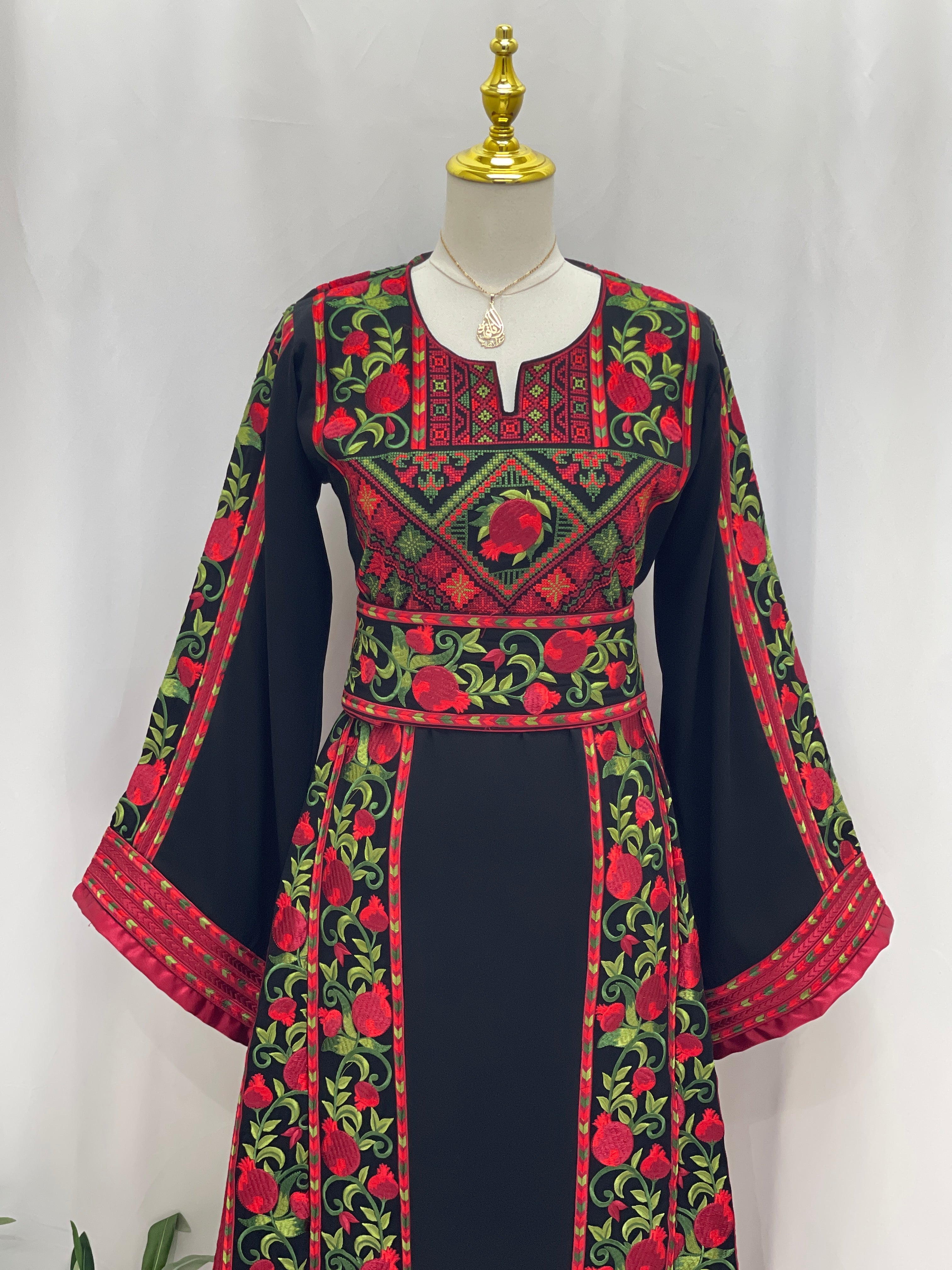 Al Romana Pomegranate Embroidered Thoub by Palestinian Elegance with intricate red and green embroidery