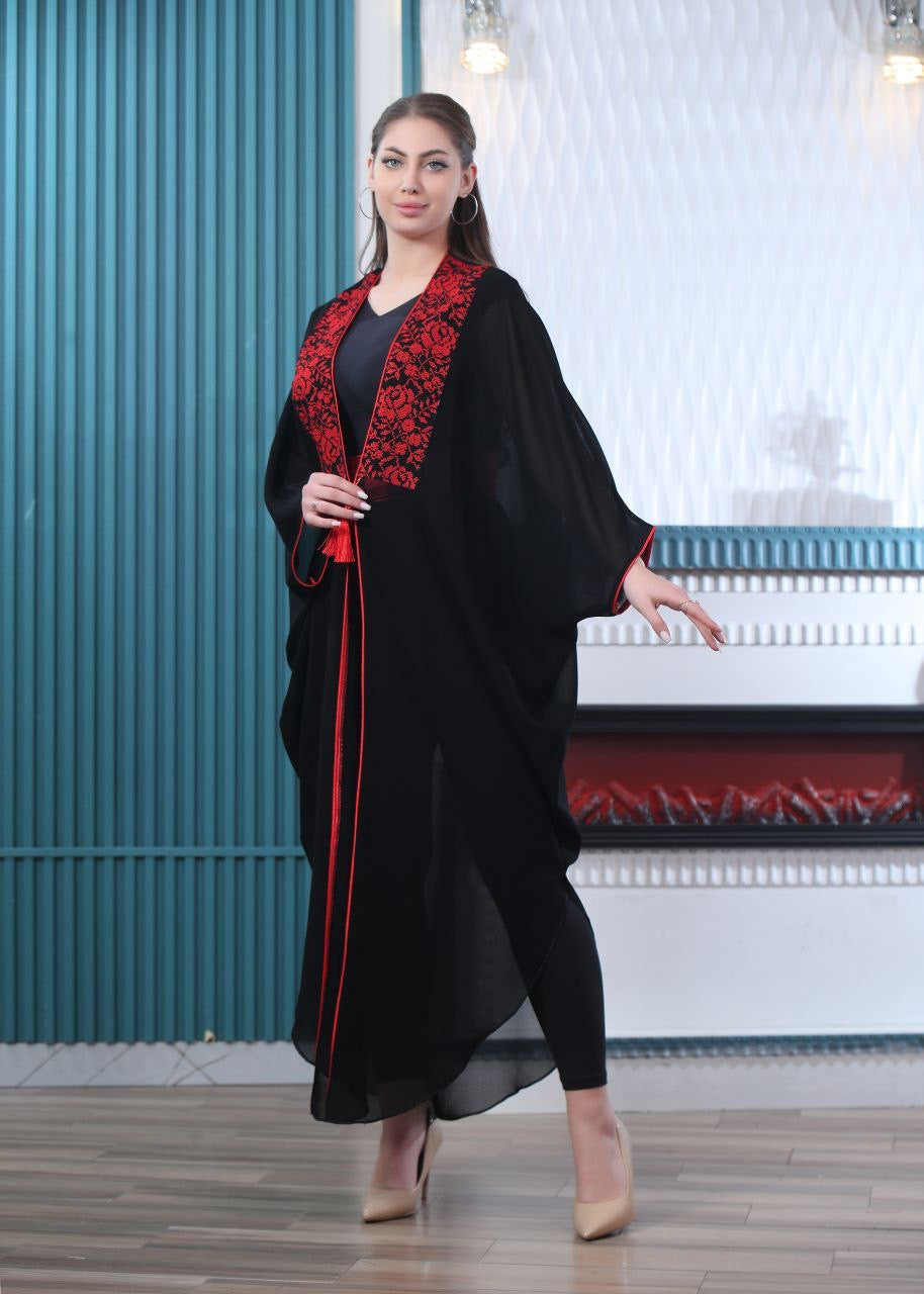 Luxury embroidered bisht by Palestinian Elegance black with red floral embroidery worn by woman