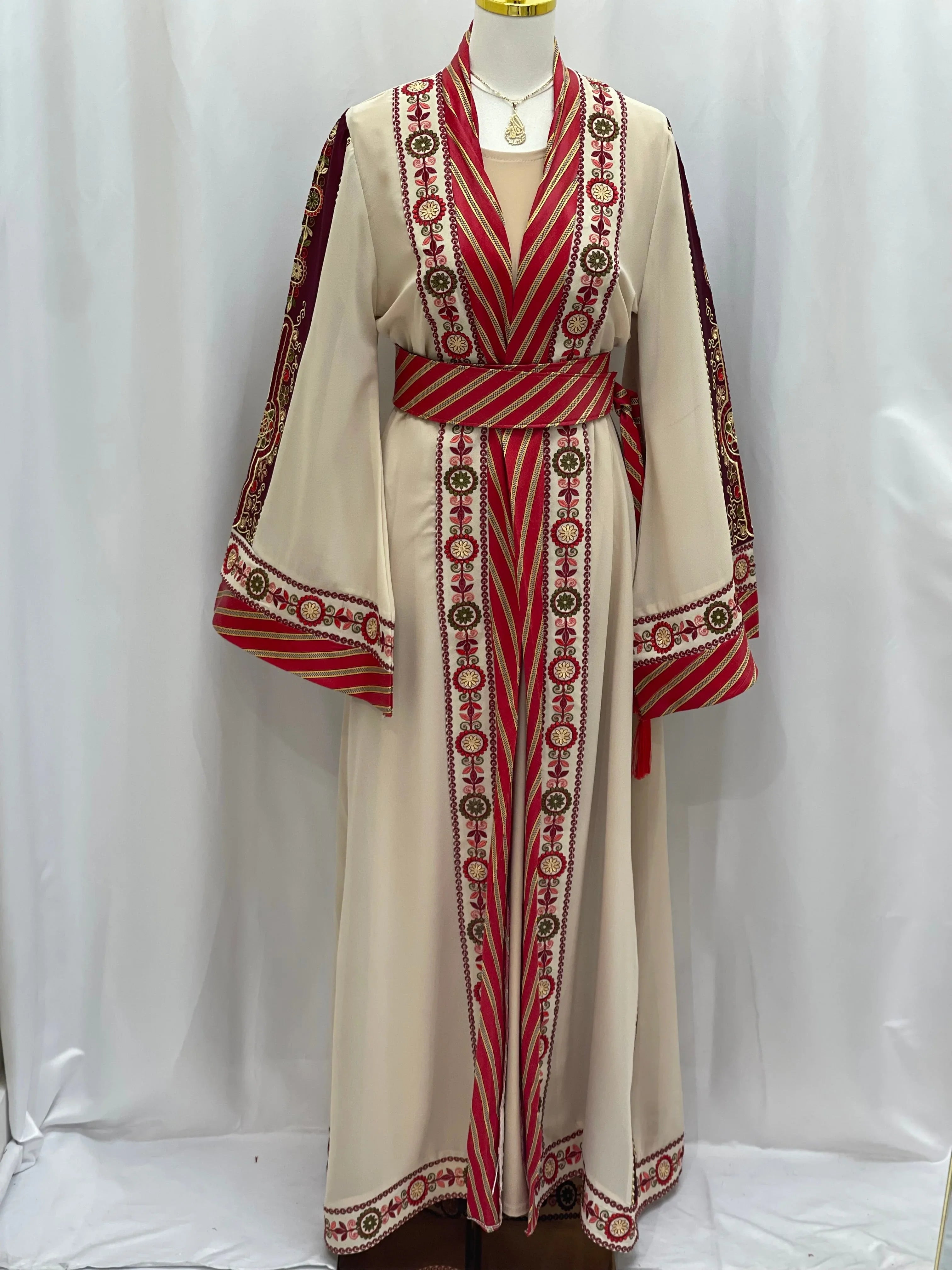 Palestinian Elegance embroidered Kashmir abaya with intricate red and gold embroidery on cream fabric and matching belt
