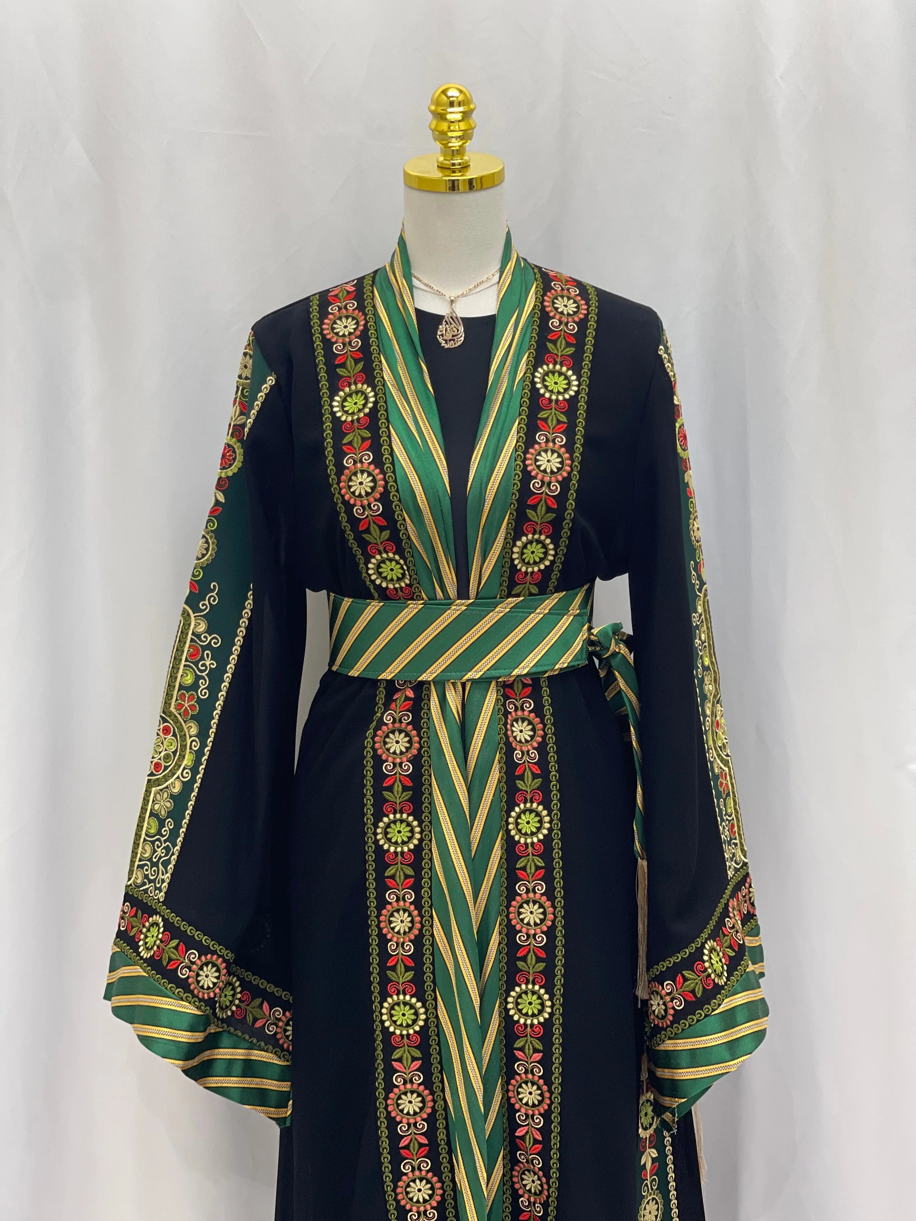 Palestinian Elegance embroidered Kashmir abaya with intricate floral embroidery and green striped accents on black fabric
