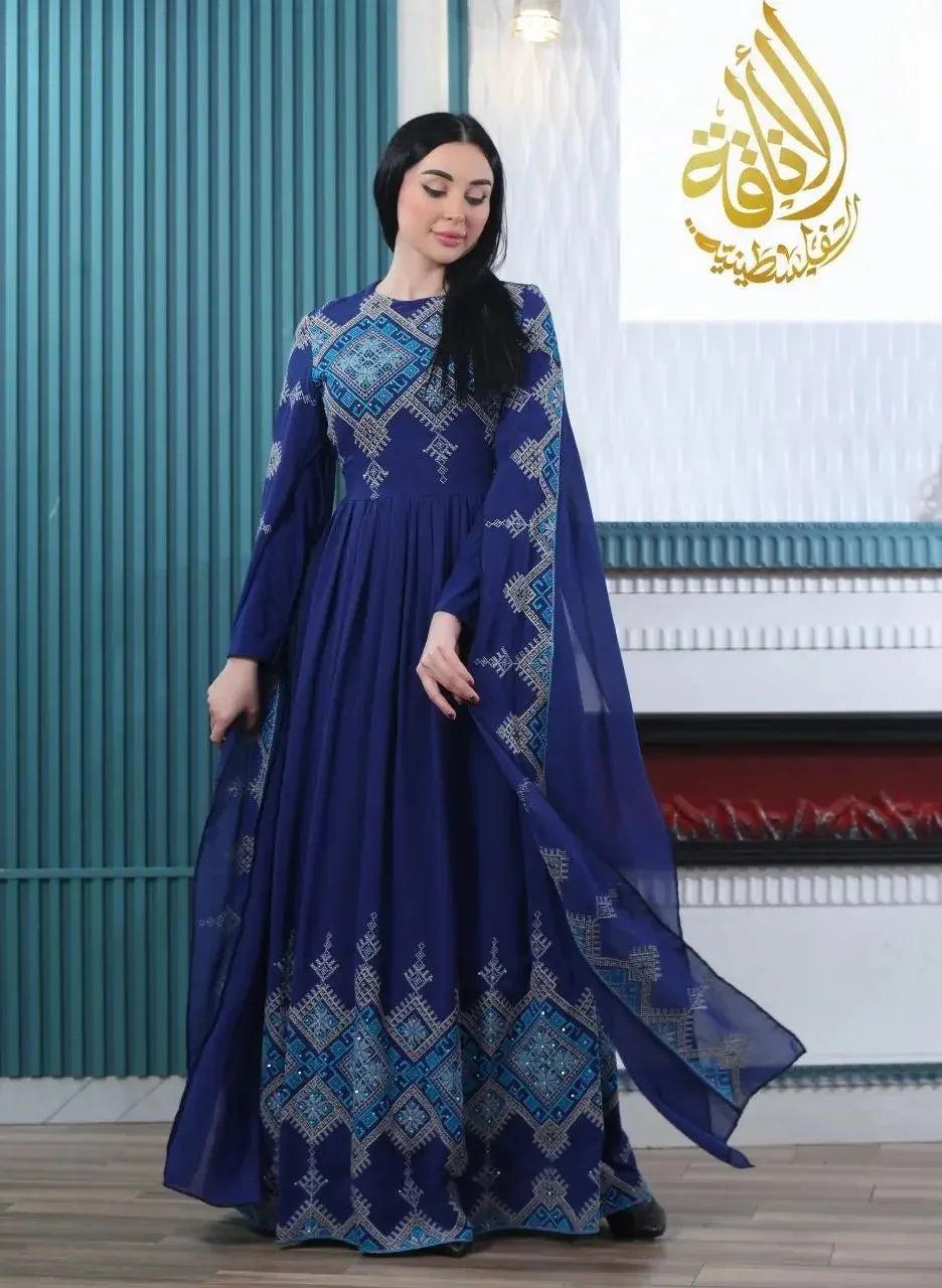 Woman wearing a modern embroidered Palestinian dress in deep blue with intricate geometric embroidery