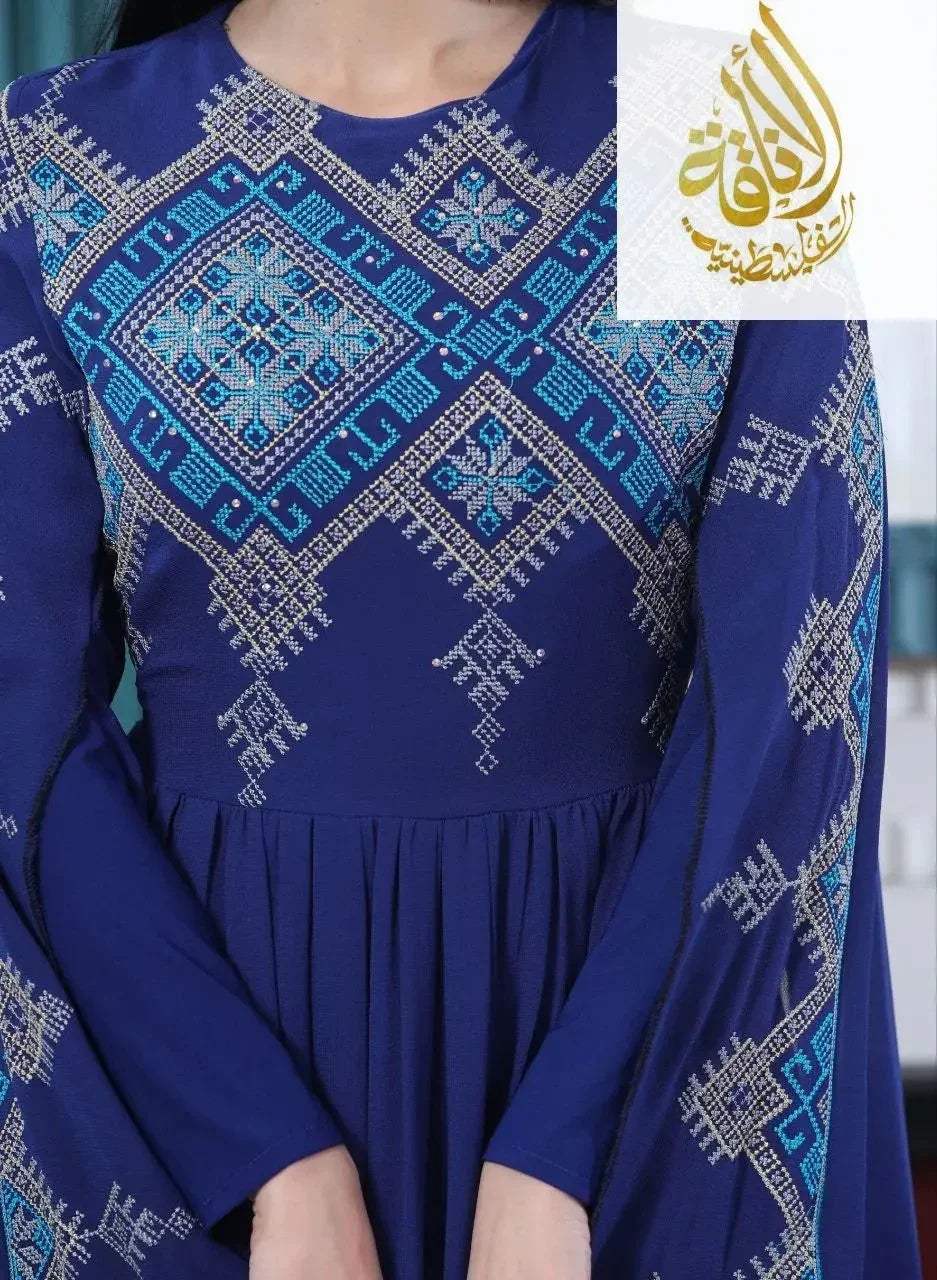 Modern embroidered Palestinian dress in deep blue with intricate turquoise and beige embroidery by Palestinian Elegance