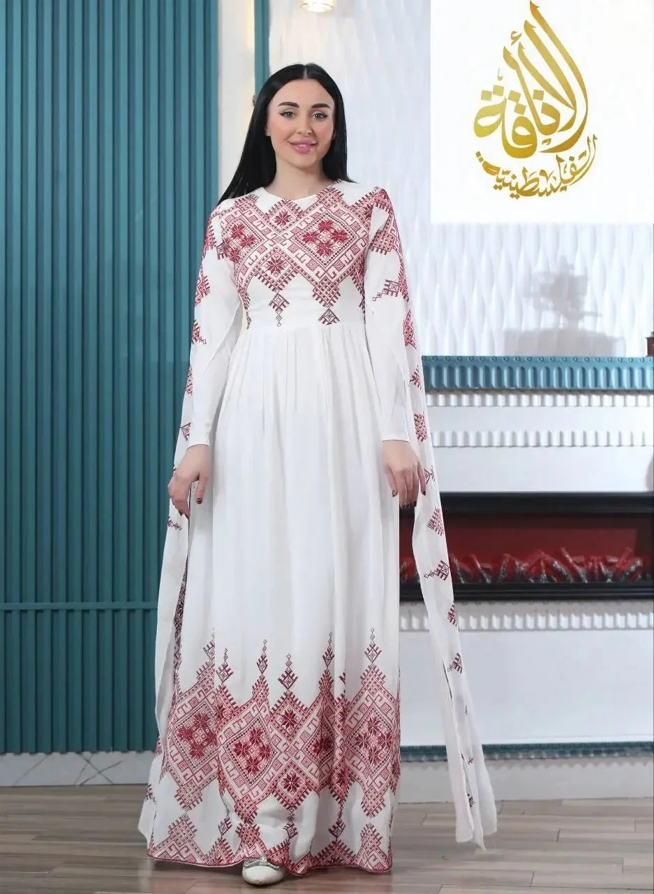 Modern embroidered Palestinian dress by Palestinian Elegance with red geometric embroidery on white fabric