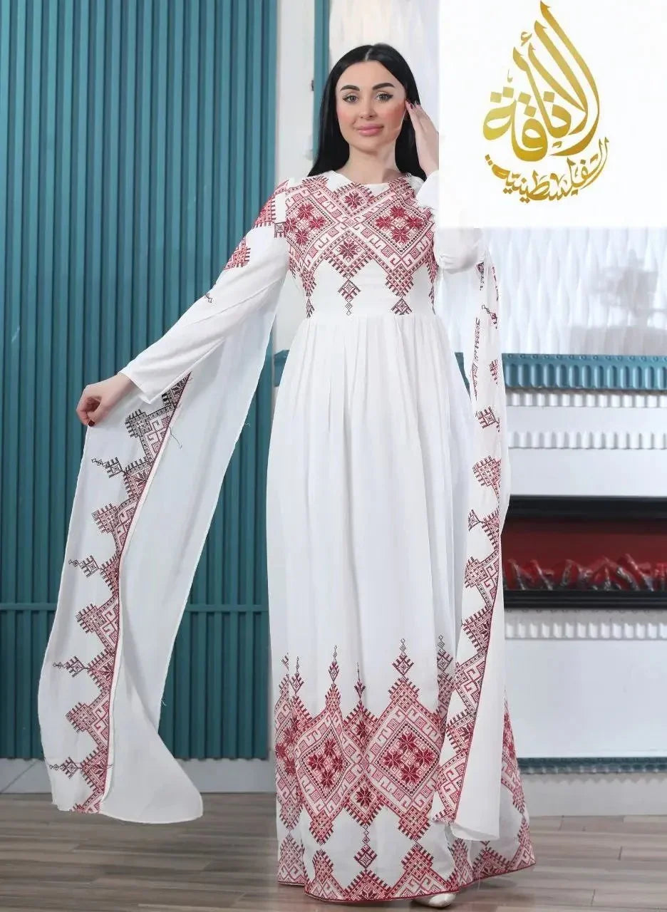 White modern embroidered Palestinian dress with red geometric patterns worn by woman