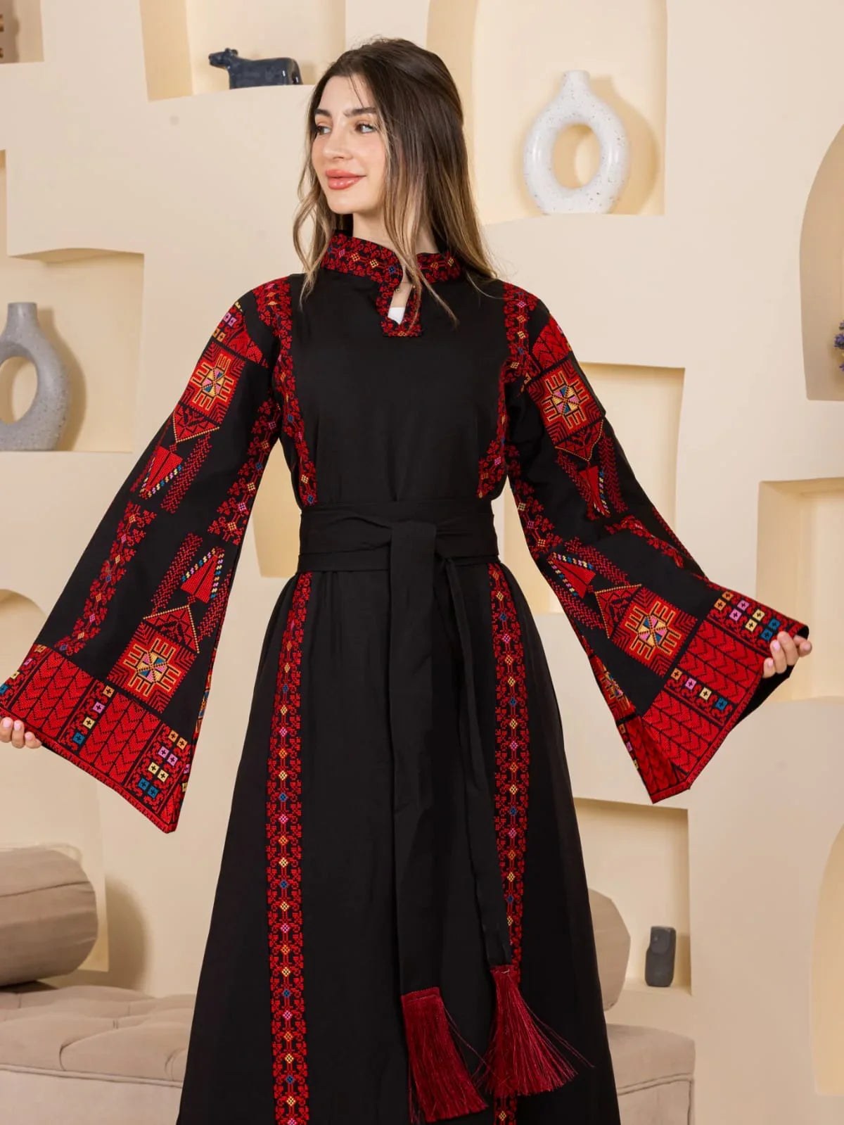 Asala Embroidered Thoub black Palestinian thobe with red embroidered bell sleeves and tassel sash