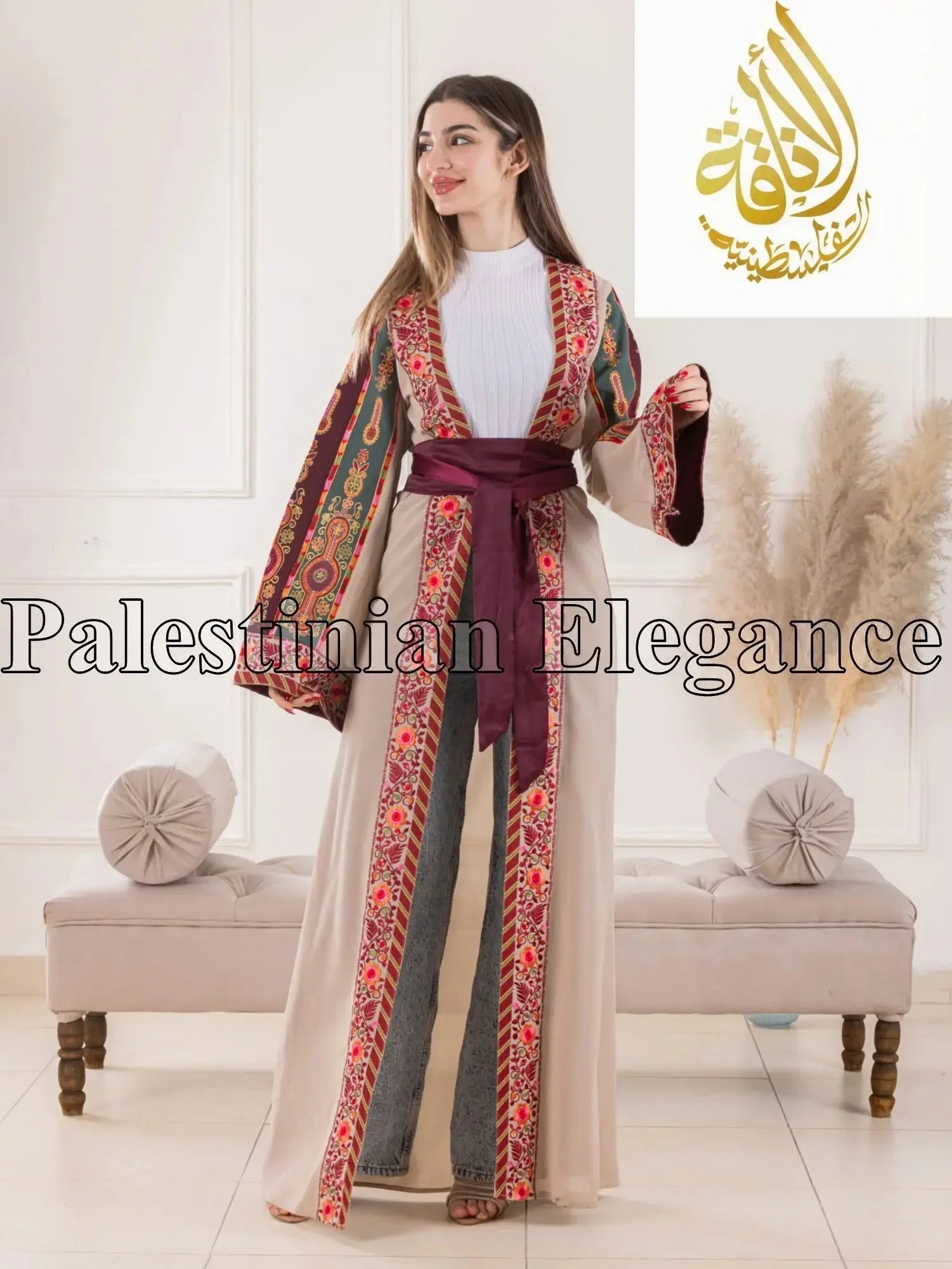 Aseel Malaka embroidered Cardigan by Palestinian Elegance worn by a woman with colorful traditional patterns and a maroon belt