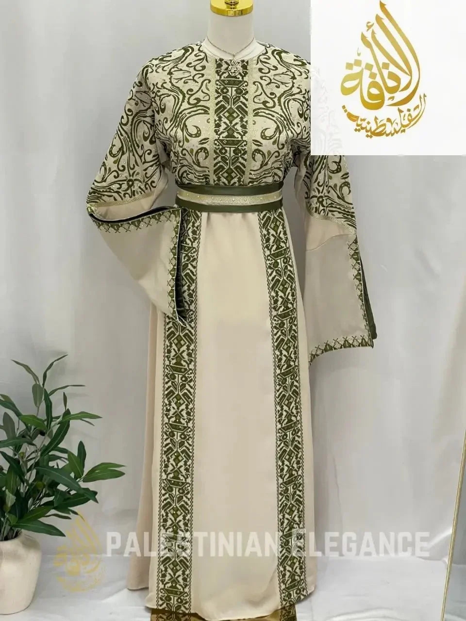 Palestinian embroidered thoub with intricate green embroidery on cream fabric by Palestinian Elegance